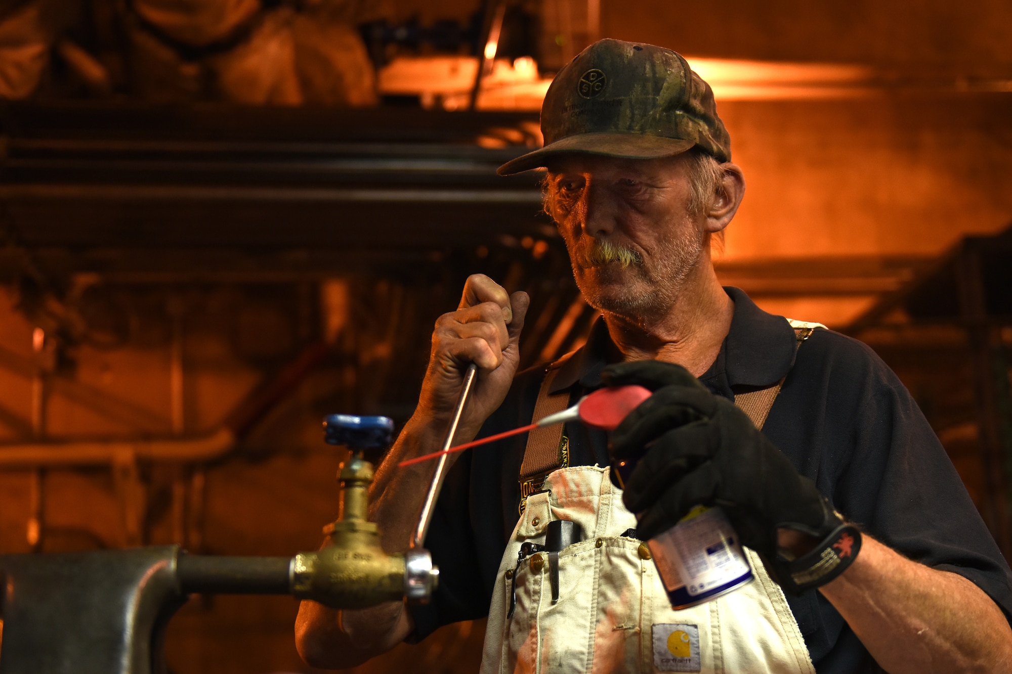 Jeffrey Olson, 341st Civil Engineer Squadron utilities systems operator, repairs a corroded cooling water line at the heat plant July 16, 2015, at Malmstrom Air Force Base, Mont. Last year the heat plant burned 154.7 million cubic feet of natural gas and 800 tons of coal. (U.S. Air Force photo/Chris Willis)