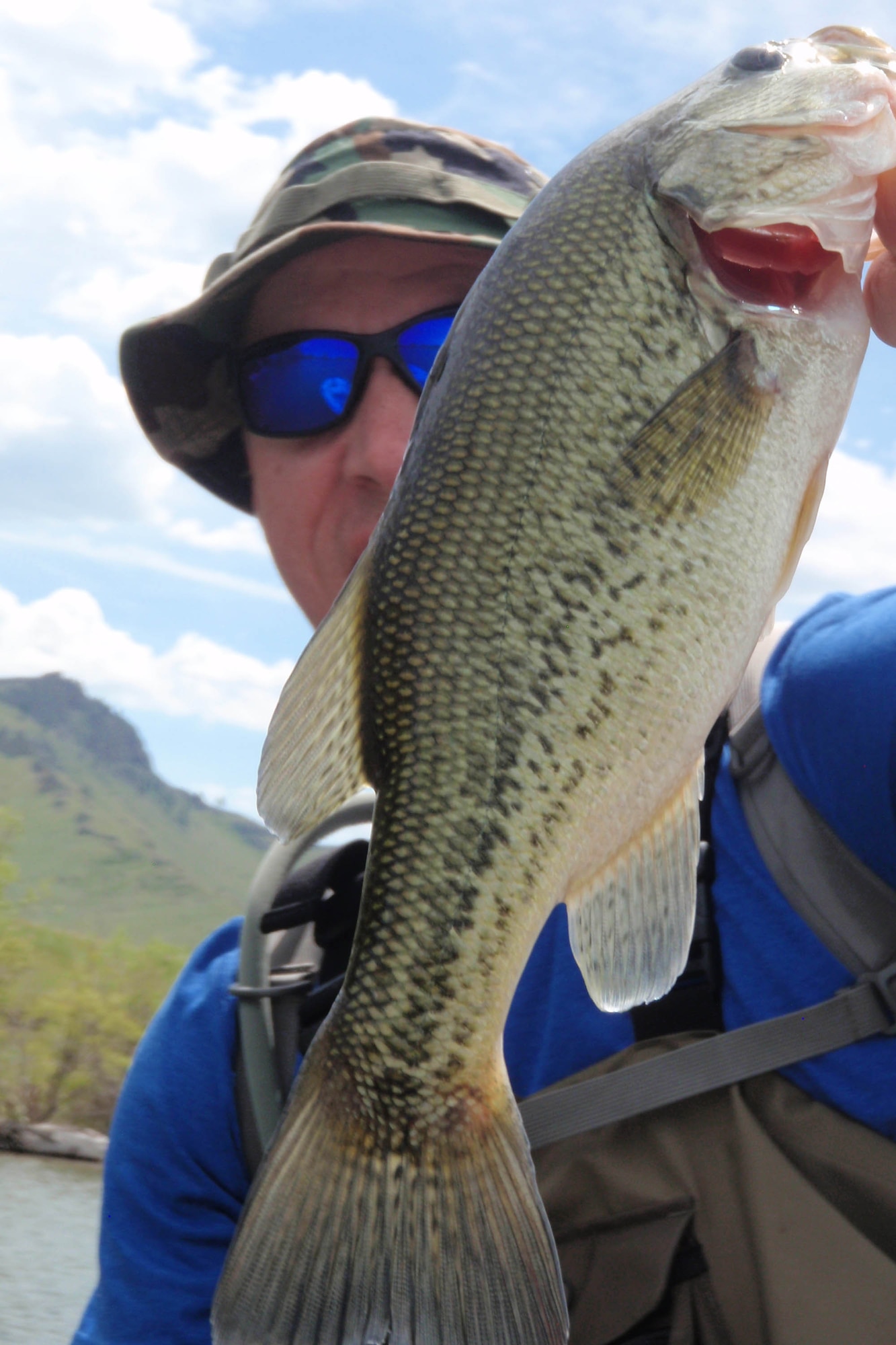 Tech. Sgt. Chad Thompson, 341st Missile Wing Public Affairs NCO in charge, shows off another large-mouth bass he caught during a recent fishing outing to Pelican Point, June 7, 2015. Thompson has fallen in love with the outdoors since arriving to Montana and fly fishing is just one way he relieves his stress. (Courtesy photo)