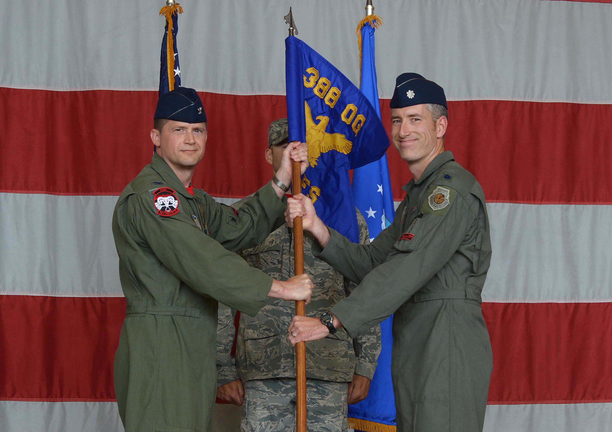 Col. David B. Lyons, 388th Fighter Wing commander, passes the guidon to Lt. Col. George R. Watkins during the 34th Fighter Squadron activation ceremony July 17 at Hill Air Force Base, Utah. The 34th will be the first combat squadron to fly the Air Force’s newest fighter aircraft, the F-35A. The squadron has an extremely rich history. After many contributions in major U.S. conflicts, the 34th was relocated to Hill AFB on Dec. 8, 1975, where they became the first fighter squadron to receive the F-16 fighter aircraft. The squadron’s first F-35A will arrive in September.  (U.S. Air Force photo by Alex R. Lloyd/Released)