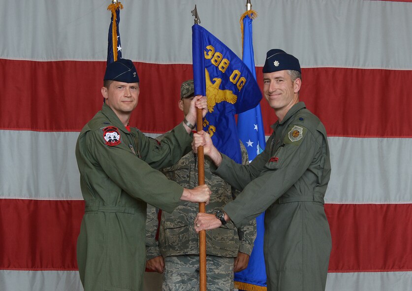 Col. David B. Lyons, 388th Fighter Wing commander, passes the guidon to Lt. Col. George R. Watkins, 34th Fighter Squadron commander, during the squadron’s activation ceremony July 17 at Hill Air Force Base, Utah. The 34th will be the first combat squadron to fly the Air Force’s newest fighter aircraft, the F-35A. The squadron has an extremely rich history. After many contributions in major U.S. conflicts, the 34th was relocated to Hill AFB on Dec. 8, 1975, where they became the first fighter squadron to receive the F-16 fighter aircraft. The squadron’s first F-35A will arrive in September.  (U.S. Air Force photo by Alex R. Lloyd/Released)