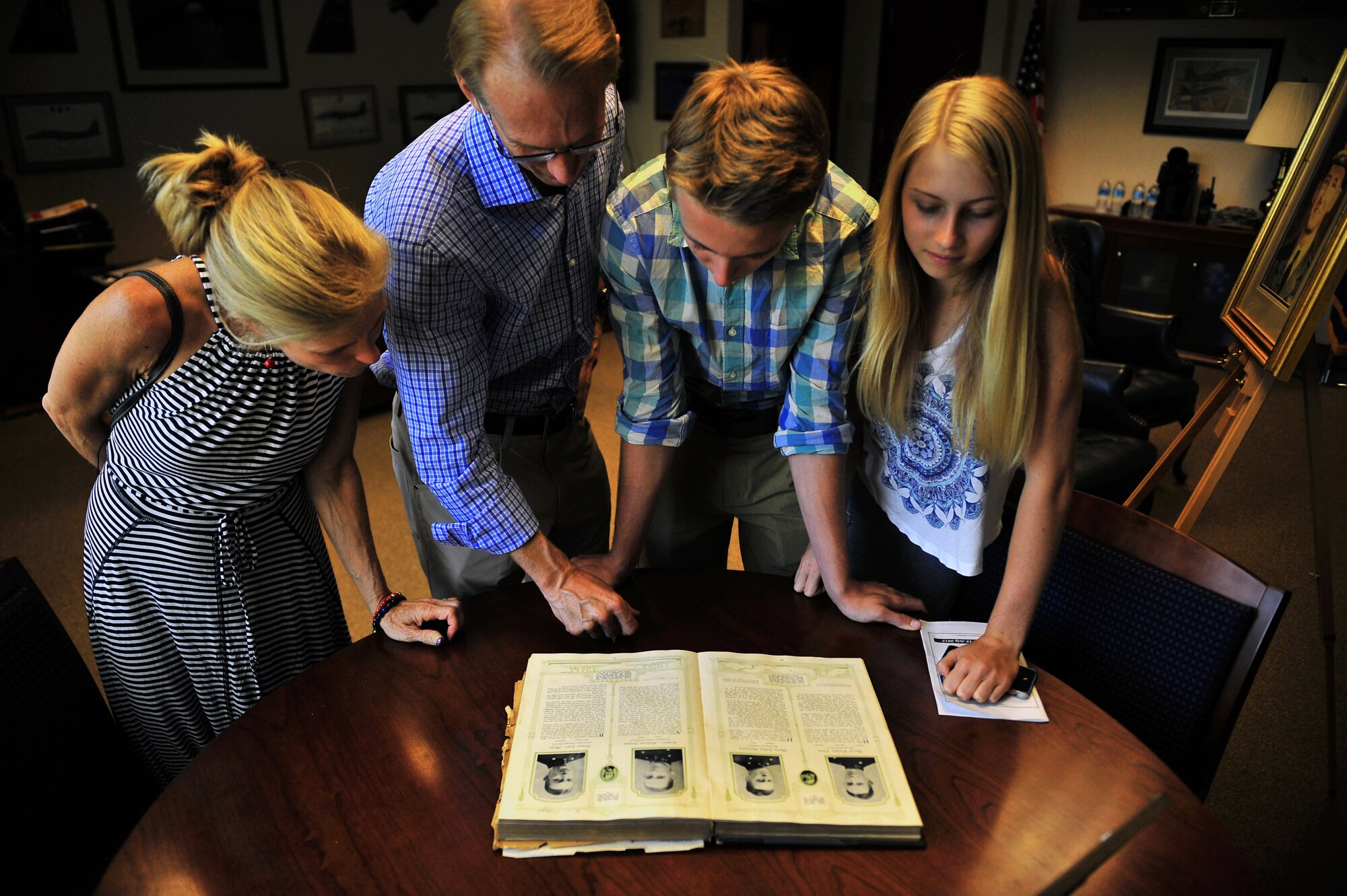Descendants of U.S. Navy Lt. Seymour Johnson read about Johnson’s legacy during a base tour, July 15, 2015, at Seymour Johnson Air Force Base, North Carolina. After meeting the 4th Fighter Wing commander, the family toured the kennels for a military working dog demonstration, the air traffic control tower and the weapons load facility. (U.S. Air Force photo/ Senior Airman Daniel Blackwell)