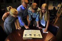 Descendants of U.S. Navy Lt. Seymour Johnson read about Johnson’s legacy during a base tour, July 15, 2015, at Seymour Johnson Air Force Base, North Carolina. After meeting the 4th Fighter Wing commander, the family toured the kennels for a military working dog demonstration, the air traffic control tower and the weapons load facility. (U.S. Air Force photo/ Senior Airman Daniel Blackwell)