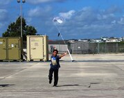 Christopher Foster, a student at DoD STARBASE-Kelly, catches his model rocket after it parachutes to earth following a successful launch, July 17, 2015 at the 433rd Airlift Wing, Joint Base San Antonio-Lackland, Texas. The summer program is open to students in fourth and fifth grade who hold a military ID Card. (U.S. Air Force photo/Tech. Sgt. Carlos J. Trevino)
