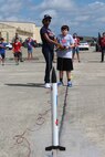 Justin Schimelpfening, son of Maj. Steven Schimelpfening 433 Operations Supports Squadron director of operations, launches his rocket at Joint Base San Antonio-Lackland, Texas on July 17, 2015 after a countdown by Trilisa Garrett, Starbase Kelly instructor.  The rockets are assembled by the students soar to heights of nearly 200 feet and during the week long class. (U.S. Air Force photo/Tech. Sgt. Carlos J. Trevino) 