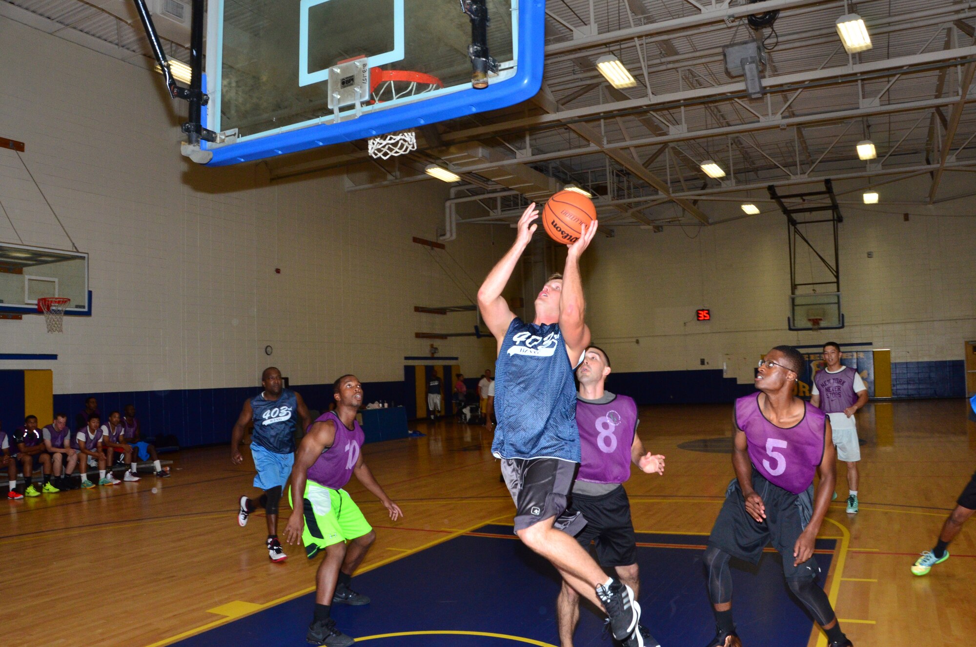 Maj. Domenic Barberi goes in for a layup during the second game of the 2015 Keesler Air Force Base intramural basketball season July 15 at the Blake Fitness Center.