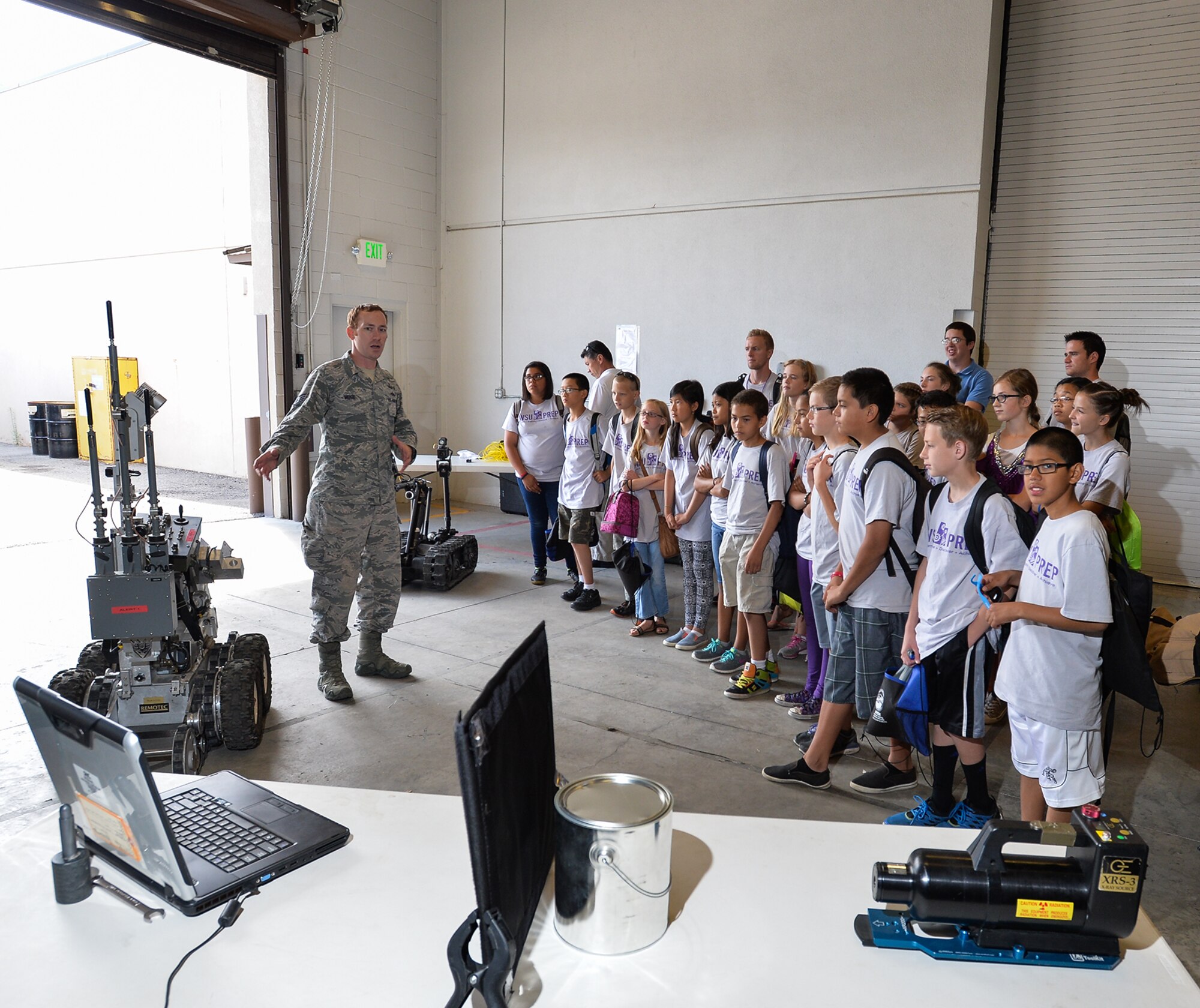 WSU PREP participants listen as Staff Sgt. Matthew Muse, an explosive ordnance disposal technician assigned to the 775th Civil Engineer Squadron, describes a robot designed to interrogate potential explosive threats during a July 17 visit to Hill Air Force Base, Utah. WSU PREP is a summer academic program offered by Weber State University to local 6th-grade students. The program is designed to motivate participants to seek education and careers in science, technology, engineering, and mathematics (STEM). Program participants were at Hill to witness firsthand how technology benefits their country. (U.S. Air Force photo/Ron Bradshaw)