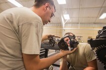 U.S. Air Force Staff Sgt. Chad Ufholz, right, 23d Equipment Maintenance Squadron weapons armament system craftsman, and Senior Airman Adam Michaud, 23d EMS combat armament system team crew member, inspect a 30mm GAU-8/A gatling gun drum drive assembly during dedicated weekend duty crew July 11, 2015, at Moody Air Force Base, Ga. The armament flight weekend duty crew was created to complete phase inspections. (U.S. Air Force photo by Airman 1st Class Ceaira Tinsley/Released)