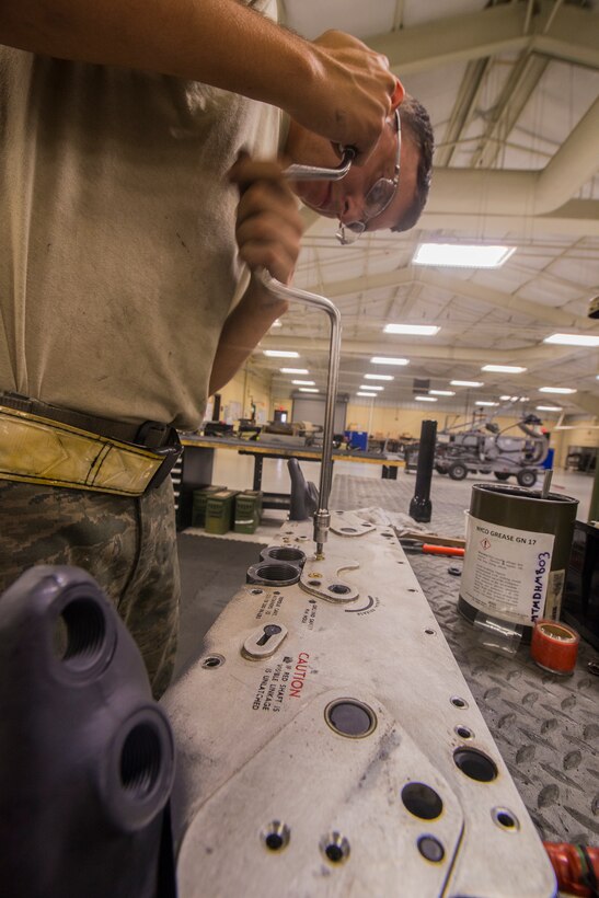 U.S. Air Force Senior Airman Adam Michaud, 23d Equipment Maintenance Squadron combat armament system team crew member, works on a A-10C Thunderbolt II bomb rack during dedicated weekend duty July 11, 2015, at Moody Air Force Base, Ga. Michaud is one of four armament flight Airmen who make up the dedicated weekend duty crew. (U.S. Air Force photo by Airman 1st Class Ceaira Tinsley/Released)