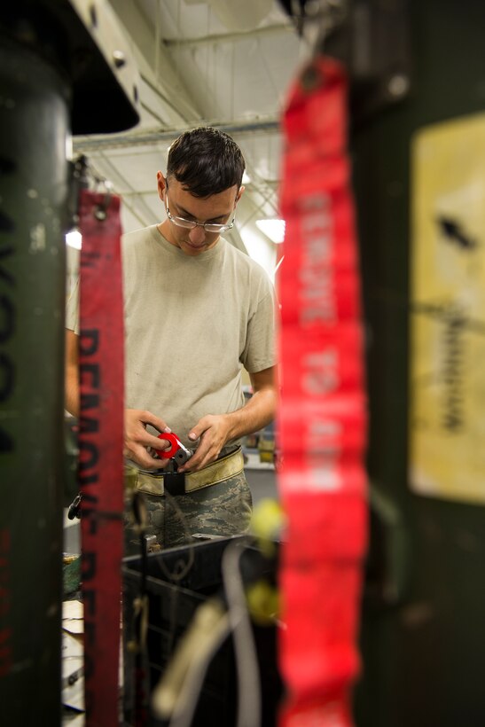 U.S. Air Force Senior Airman Adam Michaud, 23d Equipment Maintenance Squadron combat armament system team crew member, tapes an ejector piston during dedicated weekend duty  July 11, 2015, at Moody Air Force Base, Ga. The 23d EMS created a dedicated weekend duty crew to create stability in the A-10C Thunderbolt II phase inspection process. (U.S. Air Force photo by Airman 1st Class Ceaira Tinsley/Released)