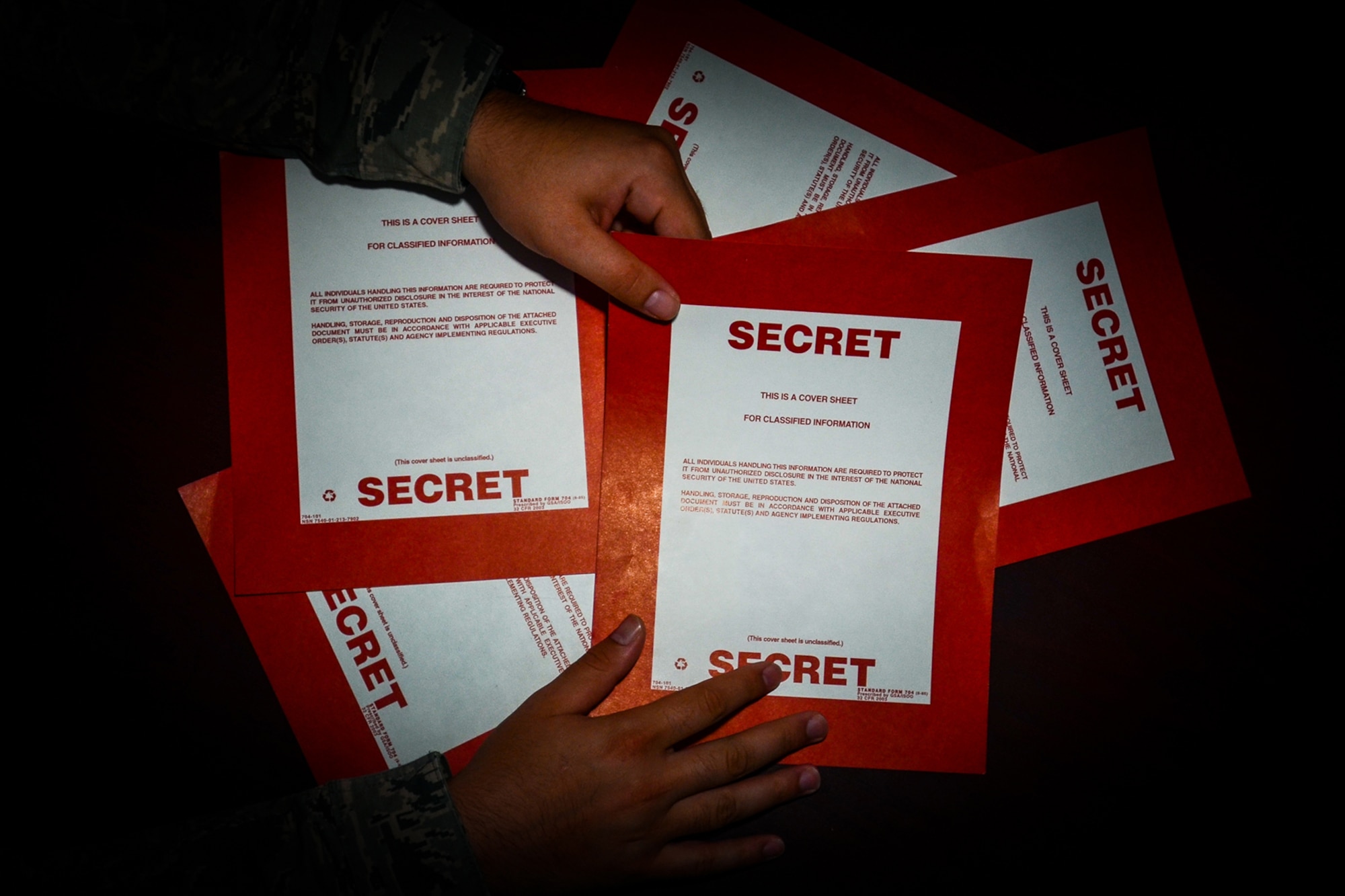 Secret cover sheets are handled by an Intel analyst with the 169th Operations Support Squadron at McEntire Joint National Guard Base, S.C., June 14, 2015.  
(S.C. Air National Guard photo by Tech. Sgt. Jorge Intriago/RELEASED)