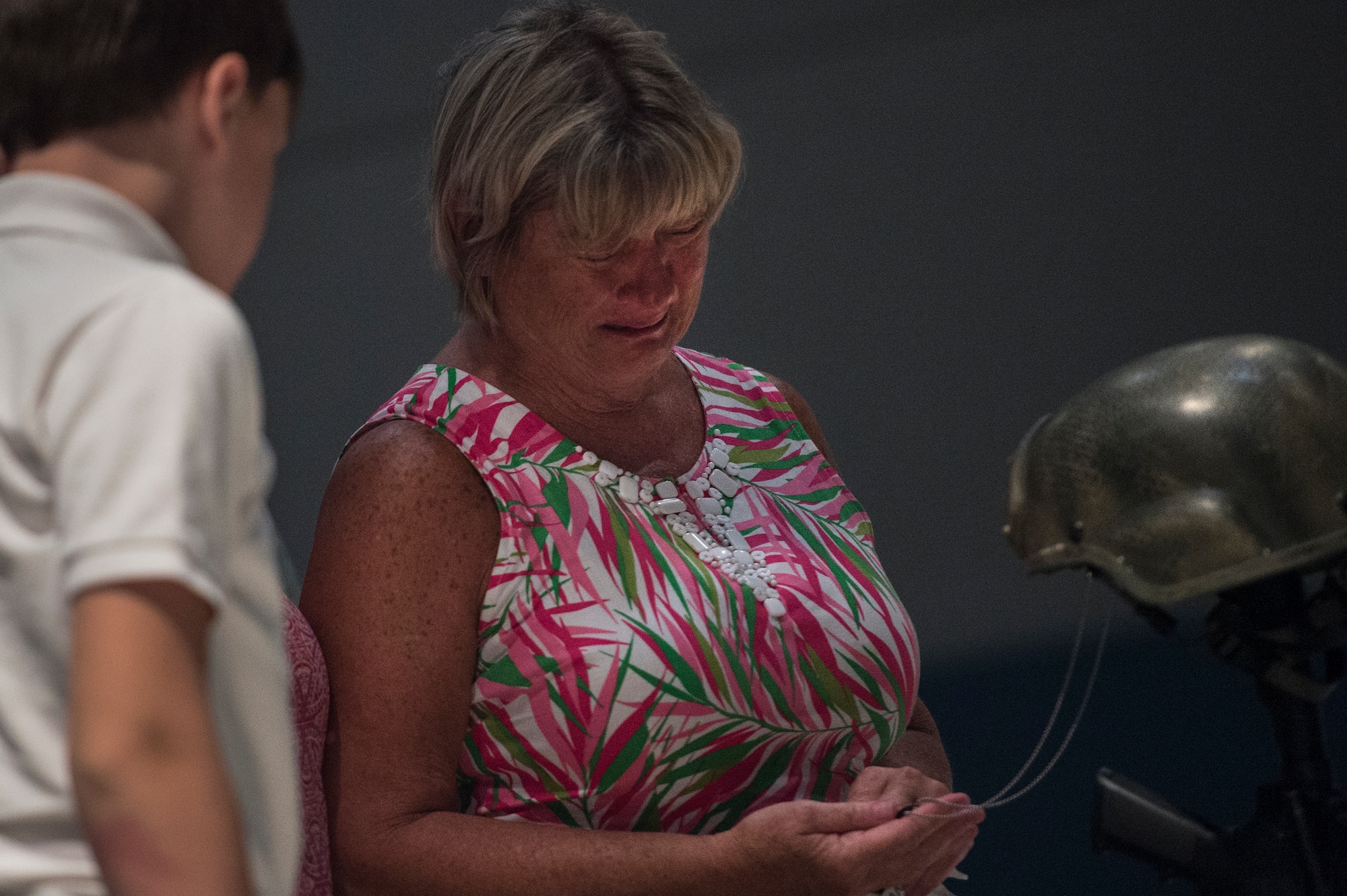 Sheila Bennet Fulp, mother of deceased Tech. Sgt. Lee Fulp, looks at his dog tags during a memorial service July 16, 2015, at Moody Air Force Base, Ga. Fulp is survived by his son, his mother, two sisters, his grandmother, and numerous aunts, uncles and cousins. (U.S. Air Force photo by Senior Airman Ryan Callaghan/Released)




