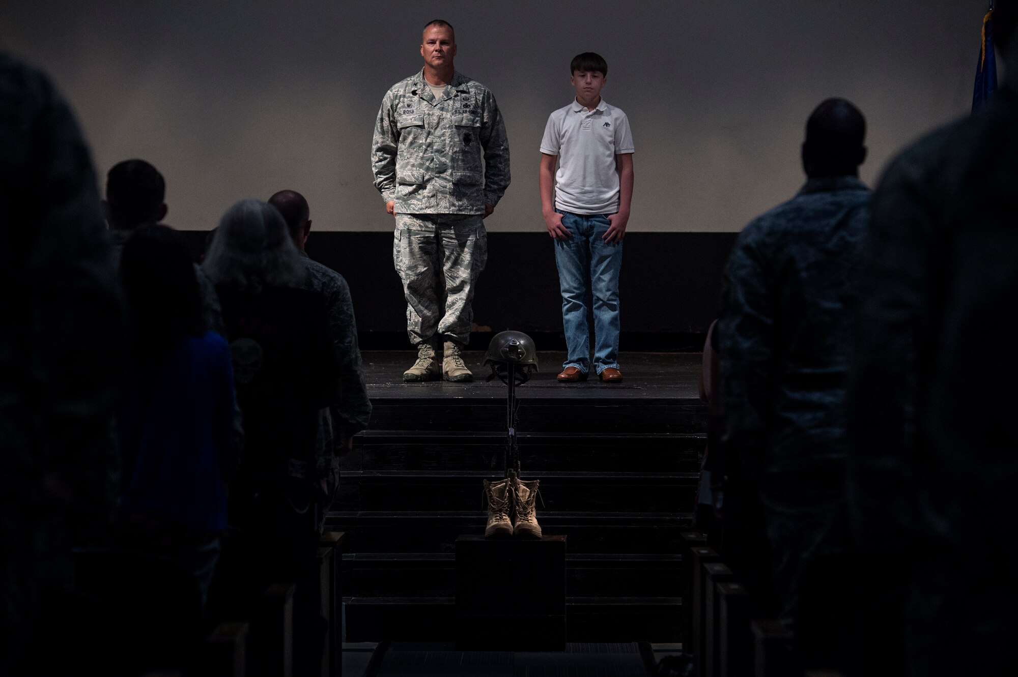 Hunter Fulp, right, son of deceased Tech. Sgt. Lee Fulp, stands next to U.S. Air Force Col. Michael Ross, 820th Base Defense Group commander, during a memorial service July 16, 2015, at Moody Air Force Base, Ga. Hunter accepted a medal, awarded posthumously, on his father’s behalf. (U.S. Air Force photo by Senior Airman Ryan Callaghan/Released)

