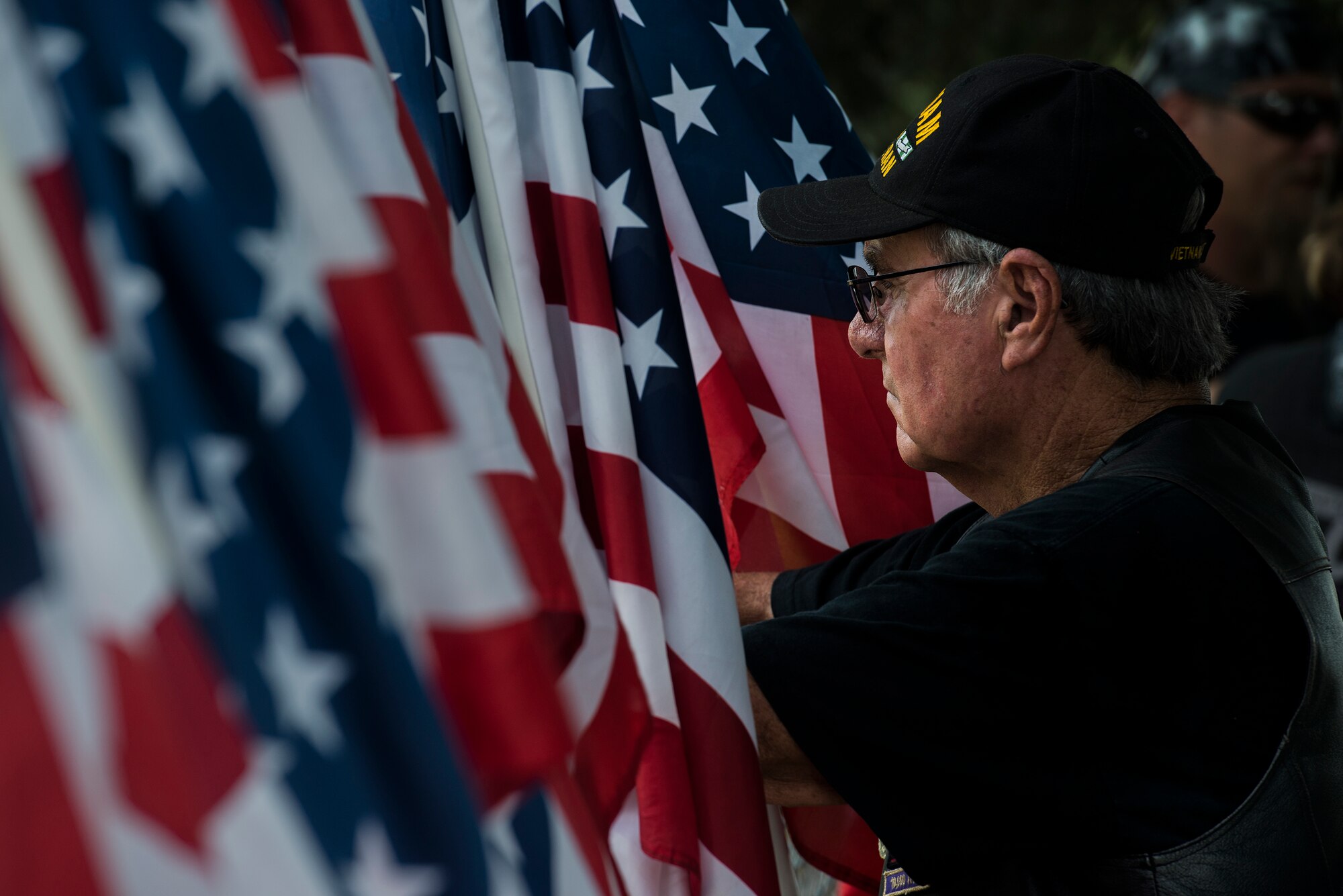 A mourner from the Christian Motorcyclists Association surveys the cemetery before the internment of deceased Tech. Sgt. Lee Fulp, July 14, 2015, at the Fellowship Baptist Church in Adel, Ga. Fulp was an avid motorcyclist and active member of the Combat Veterans Association Safeside Chapter 25-5. (U.S. Air Force photo by Senior Airman Ryan Callaghan/Released)

