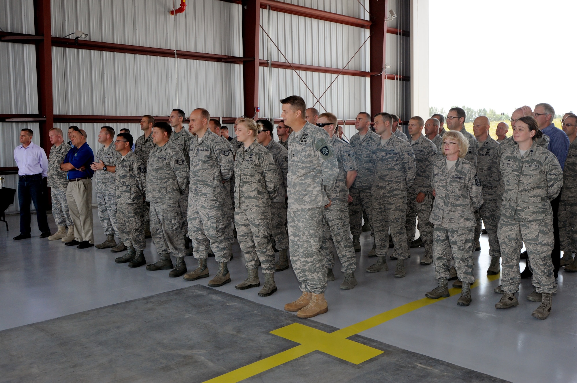 Attendees and staff of the Portland Air National Guard Base, Ore., listen to remarks during the official ribbon cutting ceremony for a new alert barn on base July 10, 2015. (U.S. Air National Guard photo by Tech. Sgt. John Hughel, 142nd Fighter Wing Public Affairs/Released)