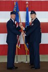 Col. Thomas Shank, left, 47th Flying Training Wing commander, presents the unit guidon to Col. Bryan Runkle during the 47th Operations Group change of command ceremony at Laughlin Air Force Base, Texas, July 17, 2015. The group consists of four flying training squadrons, an operations support squadron and a student squadron. The 47th OG provides management, control, standardization and evaluation of all aspects of flying training operations and airfield management at Laughlin. (U.S. Air Force photo by Airman 1st Class Brandon May)