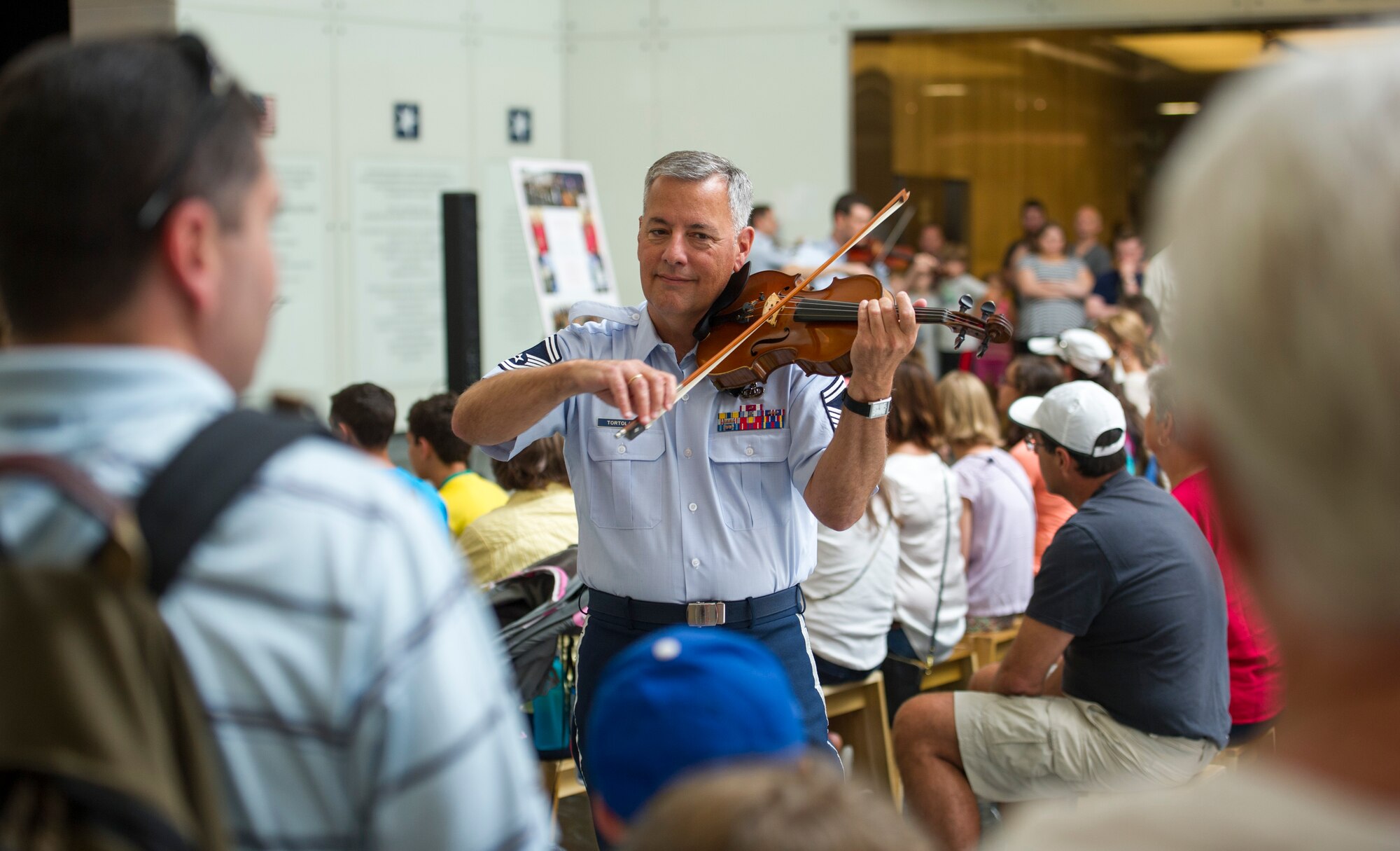 Senior Master Sgt. William Tortolano, Strolling Strings’ violinist, performs for a crowd at the National Museum of American History in Washington, D.C., July 16, 2015. The U.S. Air Force Band’s Strolling Strings concert was part of the museum’s Star-Spangled American Music Series. (U.S. Air Force photo/Airman 1st Class Ryan J. Sonnier)