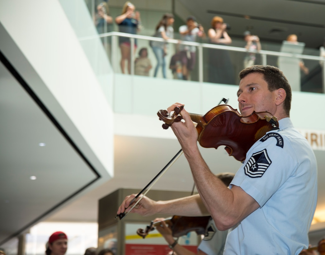 Master Sgt. Henry Tyszler, Strolling Strings’ violinist, performs for a crowd at the National Museum of American History in Washington, D.C., July 16, 2015. The U.S. Air Force Band’s Strolling Strings concert was part of the museum’s Star-Spangled American Music Series. (U.S. Air Force photo/Airman 1st Class Ryan J. Sonnier)
