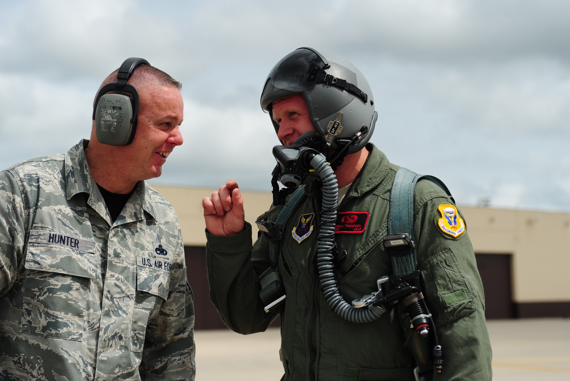Chief Master Sgt. Darron Hunter and Air Force Staff Sgt. Joshua Thompson, 509th Aircraft Maintenance Squadron, share some words following a B-2 Spirit incentive flight at Whiteman Air Force Base, Mo., July 10, 2015. Thompson was awarded the incentive flight for being named the 2012 509th Maintenance Group Crew Chief of the Year. Two other Crew Chiefs of the Year were also given incentive flights the same day. (U.S. Air Force photo by Senior Airman Joel Pfiester/Released)