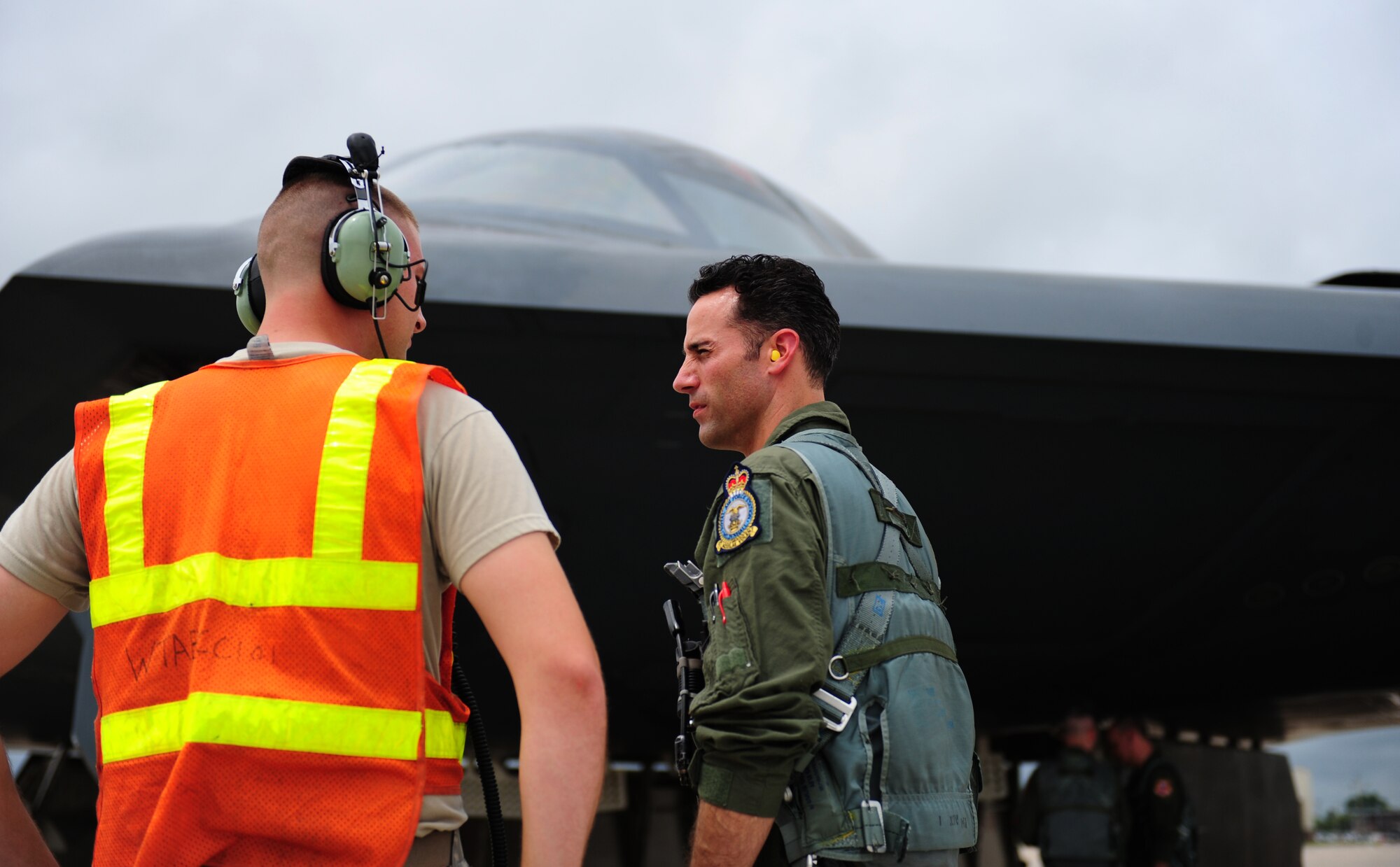 Tech. Sgt. Andrew Jones, 509th Aircraft Maintenance Squadron dedicated crew chief, shares some words with a fellow crew chief just before boarding a B-2 Spirit at Whiteman Air Force Base, Mo., July 10, 2015. Jones was awarded an incentive flight in the B-2 Spirit for being named the 2013 Air Force Global Strike Command Crew Chief of the Year. Two other Crew Chiefs of the Year were also given incentive flights the same day. (U.S. Air Force photo by Senior Airman Joel Pfiester/Released)