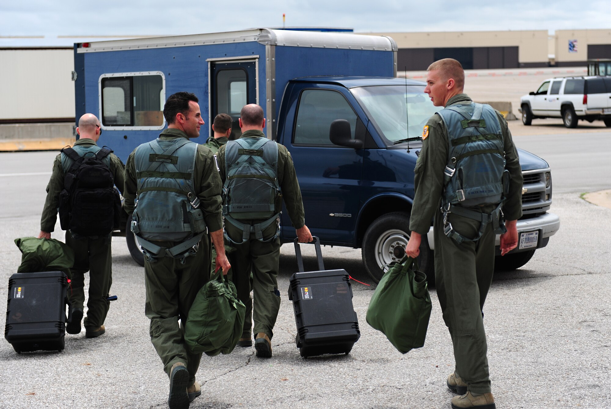 Incentive fliers and pilots load into a vehicle prior to flying in a B-2 Spirit at Whiteman Air Force Base, Mo., July 10, 2015. Three dedicated crew chiefs were awarded with the incentive flights for being named Crew Chiefs of the Year at the group and MAJCOM levels. (U.S. Air Force photo by Senior Airman Joel Pfiester/Released)