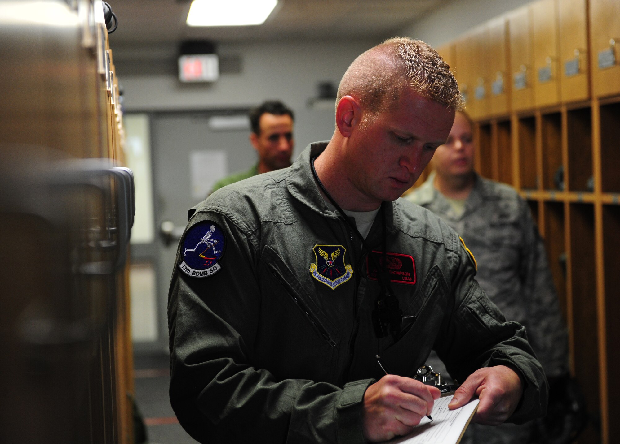 Air Force Staff Sgt. Joshua Thompson, 509th Aircraft Maintenance Squadron dedicated crew chief, signs out flight equipment prior to being an incentive rider on a B-2 Spirit at Whiteman Air Force Base, Mo., July 10, 2015. Before flying, Thompson, along with two other dedicated crew chiefs, attended briefings, Aerospace Physiology Training and received flight physicals. (U.S. Air Force photo by Senior Airman Joel Pfiester/Released)