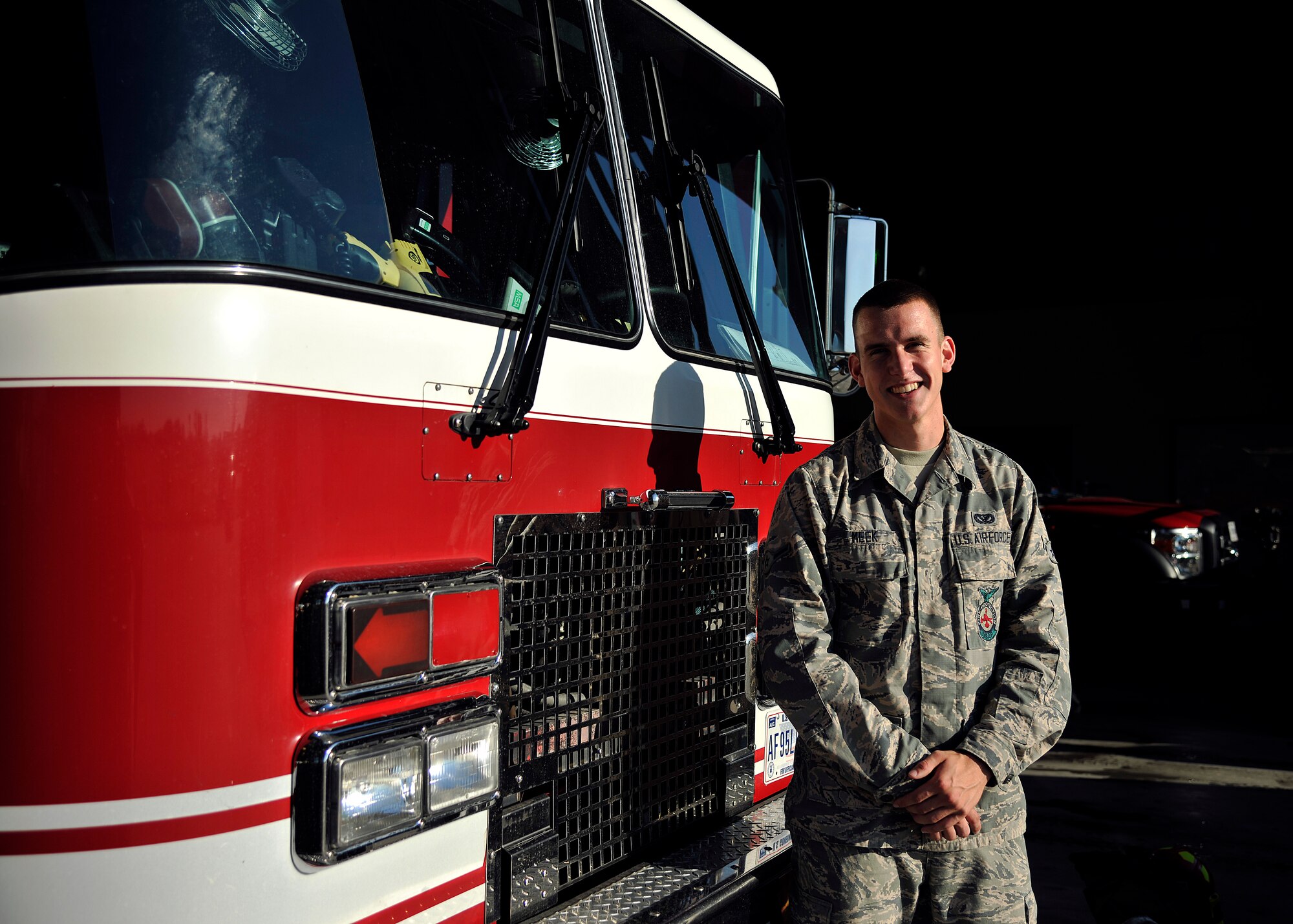 Airman Dylan Meek, 319th Civil Engineer Squadron firefighter, poses in front of a fire truck July 17, 2015 on Grand Forks Air Force Base, N.D. Meek was named Warrior of the Week for the third week of July 2015. (U.S. Air Force photo by Senior Airman Xavier Navarro/released) 
