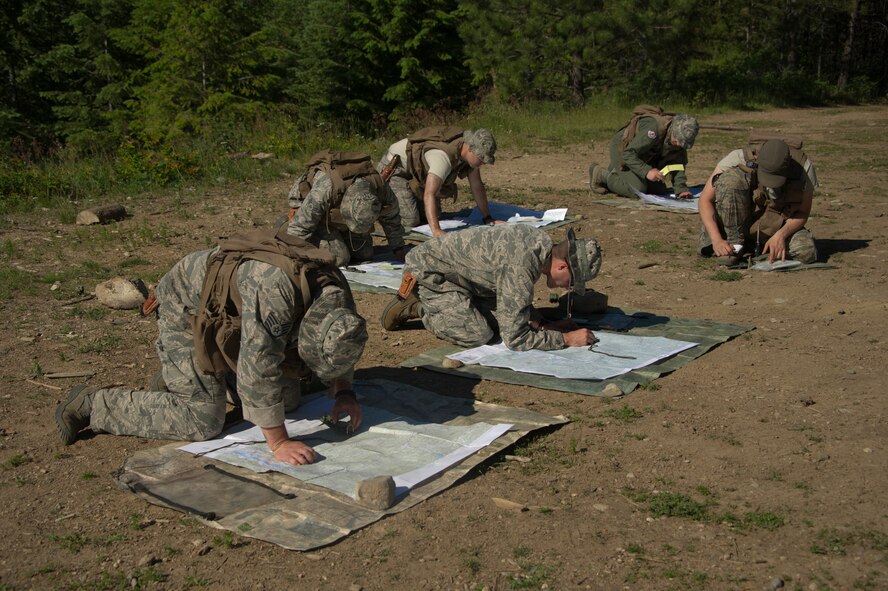 S-V-80-A combat survival students create a six-point checklist using their compass and field area training maps June 13, 2015, in the Colville National Forest, Wash. A six-point checklist assisted the students in keeping on track to locate their next checkpoint during their land navigation training. (U.S. Air Force photo/Airman 1st Class Nicolo J. Daniello)