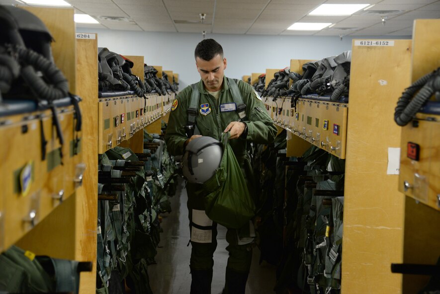 2nd Lt. Ermal Goci, 47th Student Squadron student pilot, suits up in the “pegroom” at Laughlin Air Force Base, Texas, July 14, 2015. Prior to his flight, Goci is fitted with a  g-suit, harness and helmet. The G-suit is designed to keep the pilot from blacking-out from a G-induced loss of consciousness caused by the blood pooling in the lower part of the body when under acceleration. (U.S. Air Force photo by Airman 1st Class Brandon May)