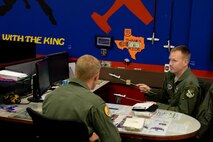 Maj. John Camponovo, 96th Flying Training Squadron T-6 Texan II instructor pilot, conducts a post-flight debrief with 2nd Lt. Eric Sperry, 47th Student Squadron student pilot, in the Elvis Flight classroom here, July 14, 2015. During the debrief  the instructor uses the aircraft briefing sticks to discuss formation and talk about particular areas that the student’s performance is satisfactory and where it needs improvement. (U.S. Air Force photo by Airman 1st Class Brandon May)