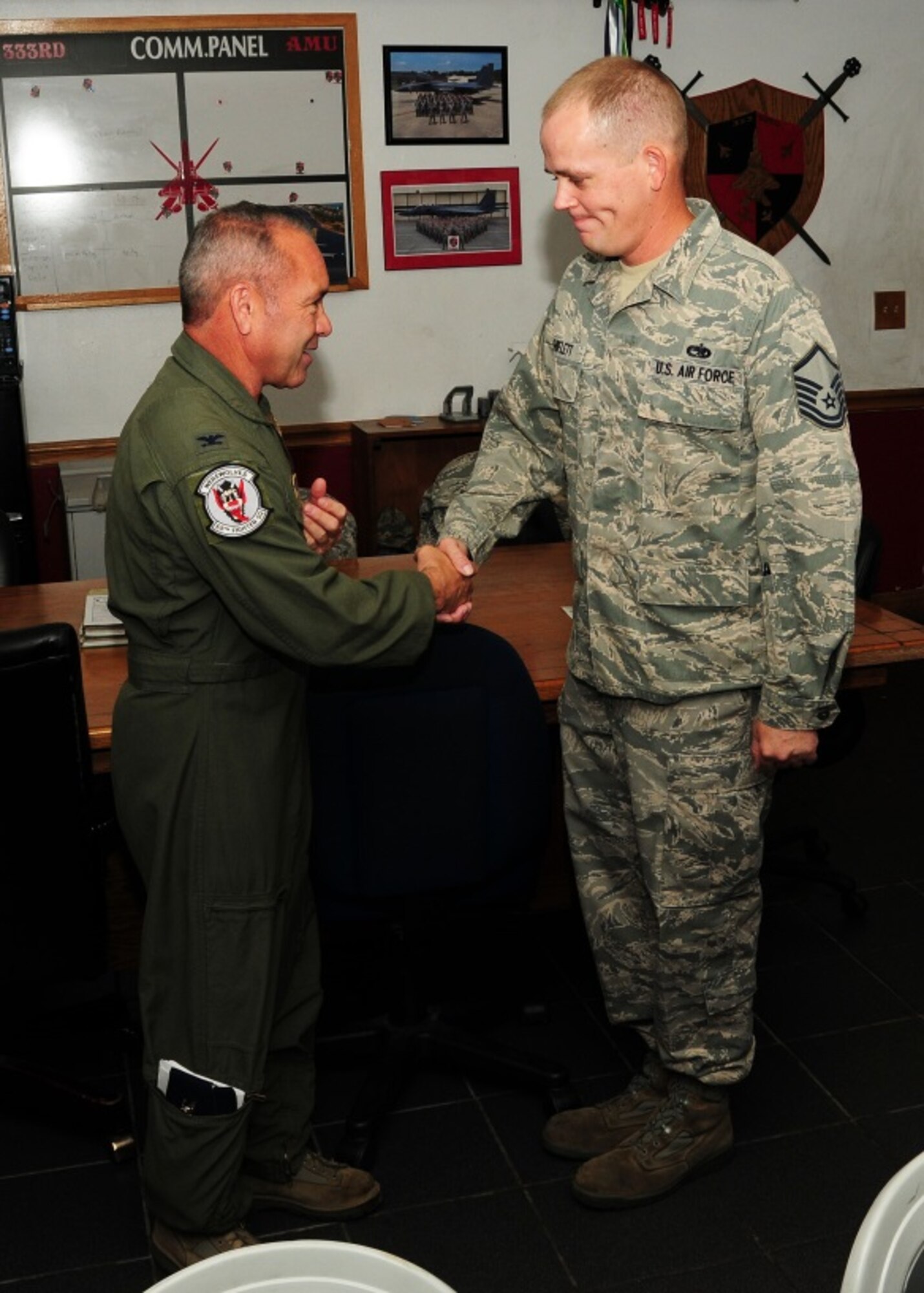 Col. Kurt Gallegos, 944th Fighter Wing commander, shakes hands with Master Sgt. Steven Shiflett, 414th Maintenance Squadron, July 10 after being recognized as a superior performer during a tour at Seymour Johnson Air Force Base, North Carolina. (U.S. Air Force photo taken by Tech. Sgt. Louis Vega Jr.)