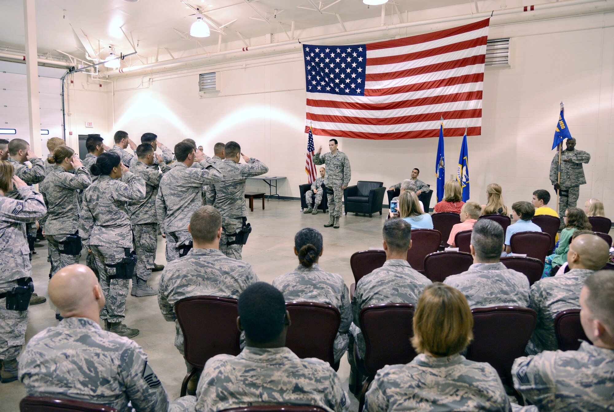 Maj. Steven Ohlmeyer receives his first salute as commander of the 72nd Security Forces Squadron during a July 8 change of command ceremony.  The major replaces Lt. Col. Frank Reyes. To signify the change of command, Colonel Reyes unloaded his weapon and Major Ohlmeyer loaded his. The major is a career defender and this will be his third assignment commanding a squadron. He told the defenders he was extremely proud to be here. “You make the squadron great,” he said. “As commander, I will take care of you and your families, and will effectively lead the squadron through upcoming challenges and opportunities and together we will make the squadron better.” (Air Force photo by Kelly White/Released)