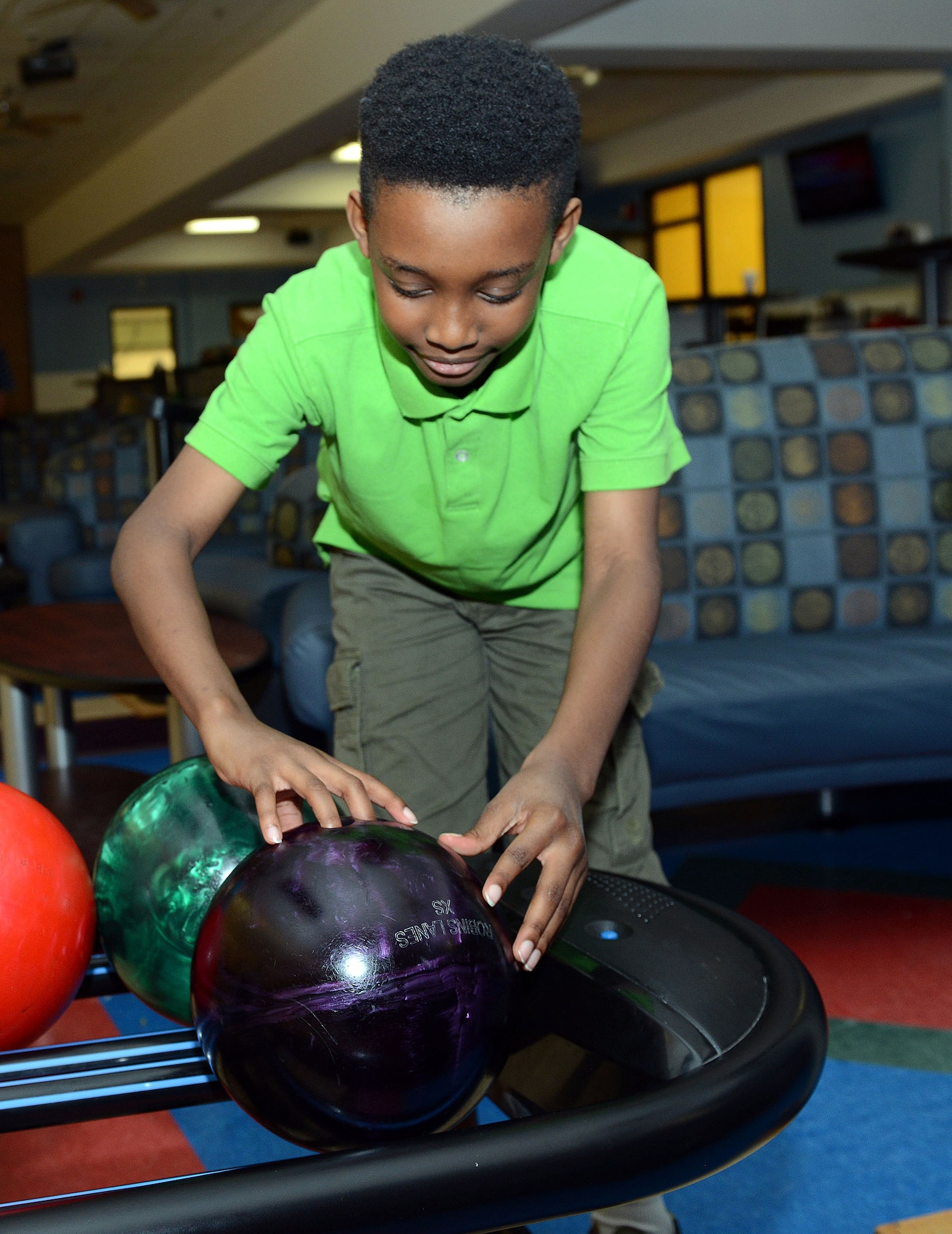 Rondell Newsome, 10, enjoys an afternoon of bowling at Robins Lanes. The bowling center is available to all active duty, retirees and their family members, Department of Defense civilians and their family members, DOD contractors and technical representatives, and guests accompanied by authorized individuals. (U.S. Air Force photo by Tommie Horton)