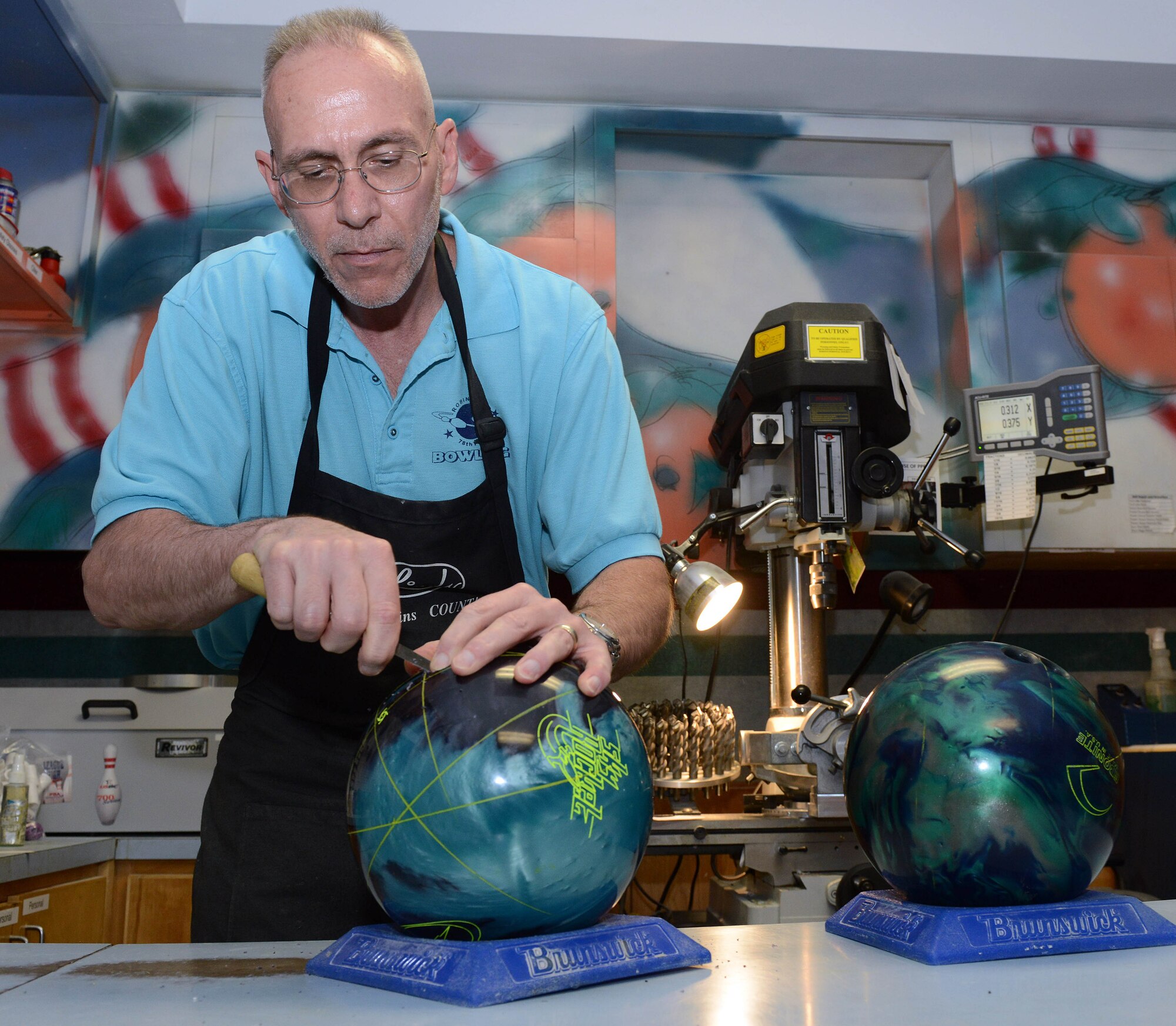 Jeff Herman, Robins Bowling Center pro shop manager, provides custom drilling service that ensures proper fitting and the most comfort for bowlers. (U.S. Air Force photo by Tommie Horton)