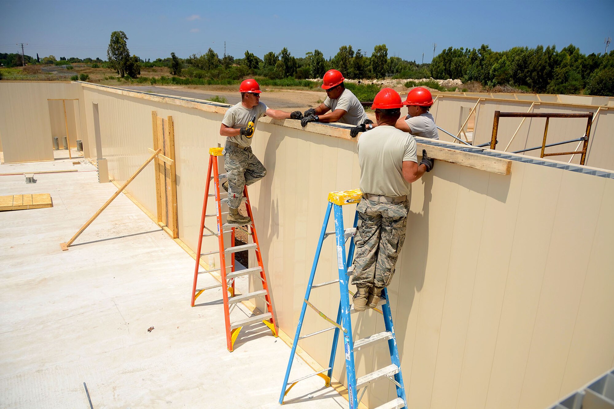 U.S. Airmen from the South Carolina Air National Guard’s 169th Civil Engineer Squadron at McEntire Joint National Guard Base, S.C., construct nuform walls for multi-purpose buildings in support of a Deployment for Training in Israel, July 8, 2015. The construction project is to help S.C. PRIME BEEF Airmen maintain their civil engineering specialties. Swamp Fox civil engineers are working alongside 200th RED HORSE Squadron and U.S. Navy SEABEES civil engineers during the training exercise. (South Carolina Air National Guard photo by Tech. Sgt. Caycee R. Watson / RELEASED)