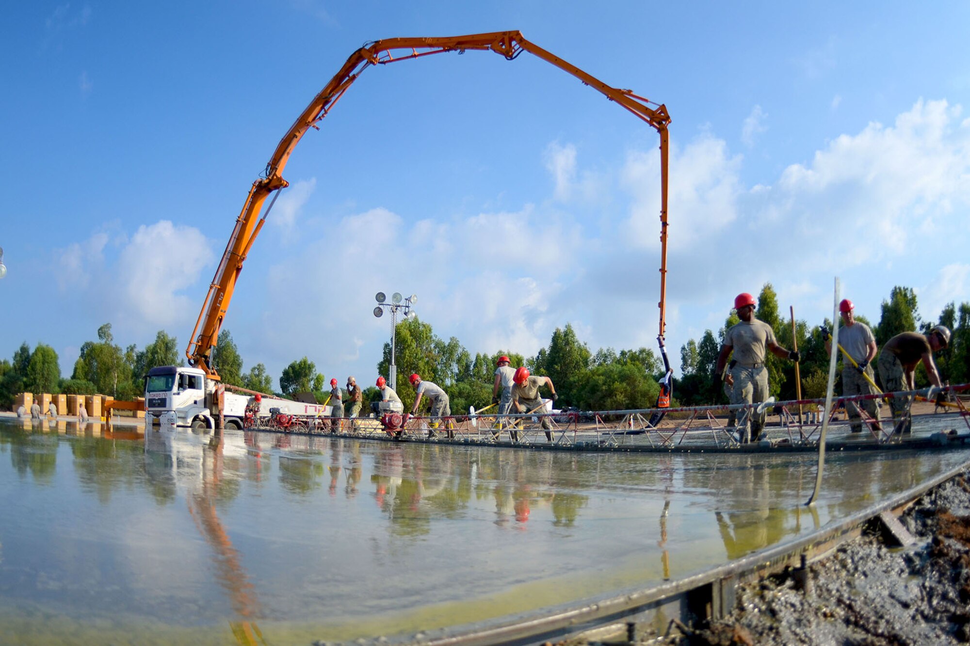 U.S. Airmen from the South Carolina Air National Guard’s 169th Civil Engineer Squadron at McEntire Joint National Guard Base, S.C., pour and level concrete foundations for multi-purpose buildings being constructed in support of a Deployment for Training in Israel, June 30, 2015. The construction project is to help S.C. PRIME BEEF Airmen maintain their civil engineering specialties. Swamp Fox civil engineers are working alongside 200th RED HORSE Squadron and U.S. Navy SEABEES civil engineers during the training exercise. (South Carolina Air National Guard photo by Tech. Sgt. Caycee R. Watson / RELEASED)