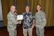 (L) Col Kenneth Moss, 43 AG Commander, and (R) CMSgt James Cope, 43 AG Superintendent, present the Air Force's 2015 Excellence in Contingency History Award to the 43 AG Historian, Mr. Daniel Knickrehm.