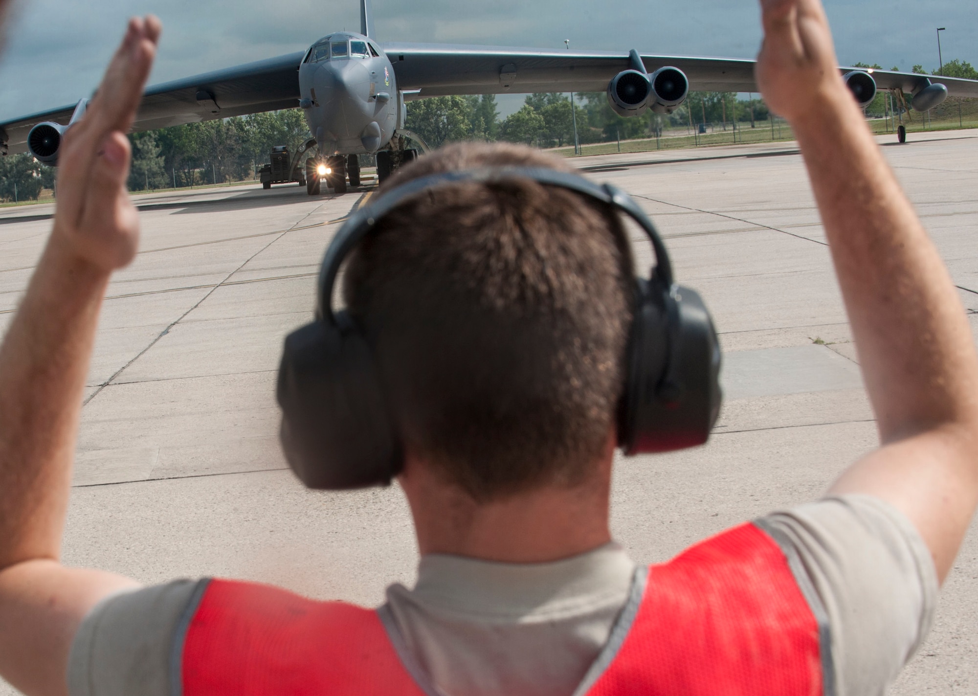 A 5th Aircraft Maintenance Squadron crew chief directs a B-52H Stratofortress during taxi at Minot Air Force Base, N.D., July 16, 2015. The crew took part in the 23rd BS’s portion of the Global Strike Challenge competition and consisted of one pilot and co-pilot, two radar and navigation specialists and an electronic warfare officer. (U.S. Air Force photo/Senior Airman Stephanie Morris)