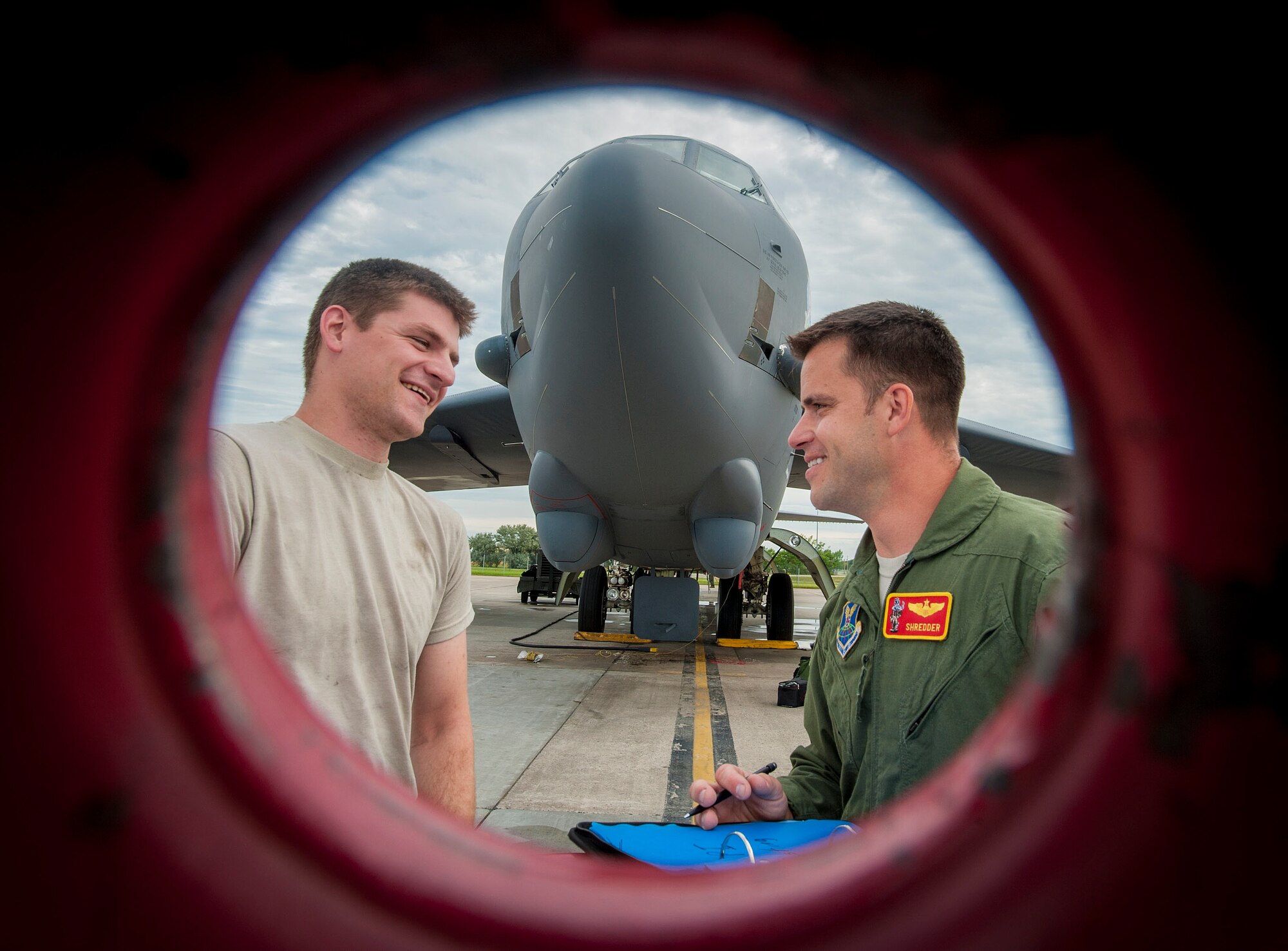 A 5th Aircraft Maintenance Squadron crew chief talks with Capt. Jeffrey ‘Shredder’, 23rd Bomb Squadron weapons and tactics flight commander at Minot Air Force Base, N.D., July 16, 2015. ‘Shredder’ and his crew took to the skies to take part in Team Minot’s first competition of Air Force Global Strike Command’s Global Strike Challenge 2015, a head-to-head contest across AFGSC’s bomber and missile wings. (U.S. Air Force photo/Senior Airman Stephanie Morris)