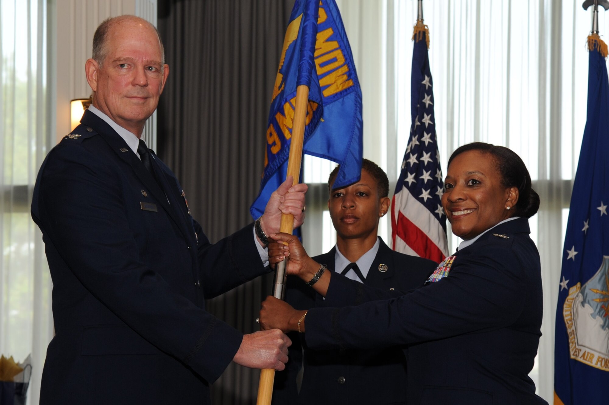 Colonel Robert Bowersox, the 79th Medical Wing Commander passes the reigns of command to Colonel Michelin Joplin who assumed command of the 579th Medical Group on Friday, July 10 at 9 a.m. at a ceremony held at the Bolling Club on Joint Base Anacostia-Bolling, Washington D.C. (AF Photo by Staff Sgt. Matthew Davis.)