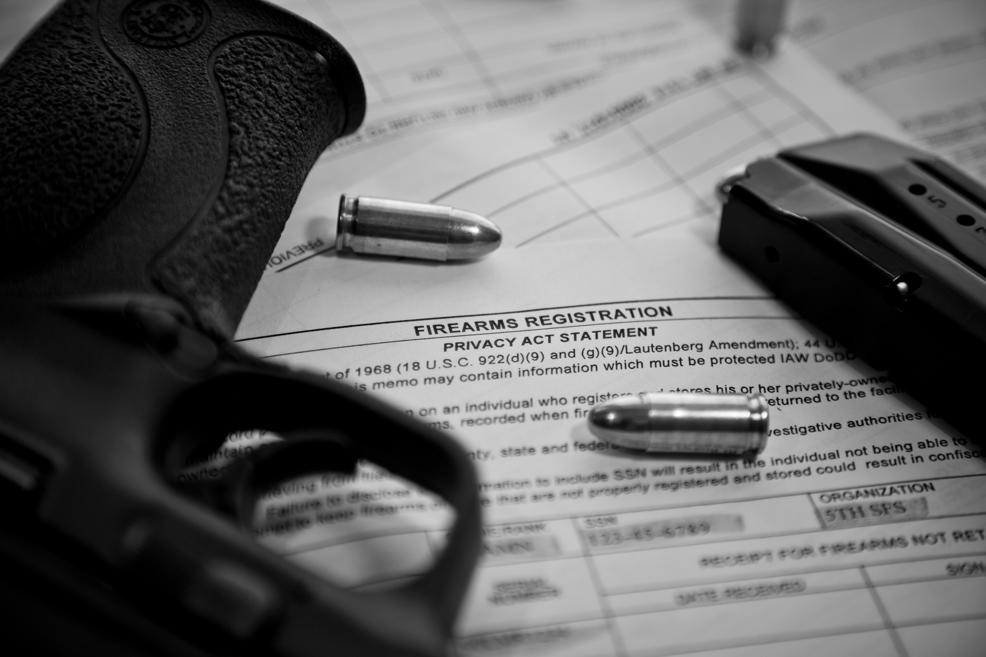 A 9 mm pistol and ammunition sit on top of an AF Form 1314 Firearms Registration form and a DD Form 2760 Qualification to Possess Firearms or Ammunitions form at Minot Air Force Base, N.D., July 10, 2015. Personnel in the dormitories, visiting quarters and temporary lodging facilities are required to store their weapons at the Armory, according to the memorandum from the 5th SFS Armory for the permanent entry or removal of personally owned weapons. (U.S. Air Force photo/Airman 1st Class Justin T. Armstrong)