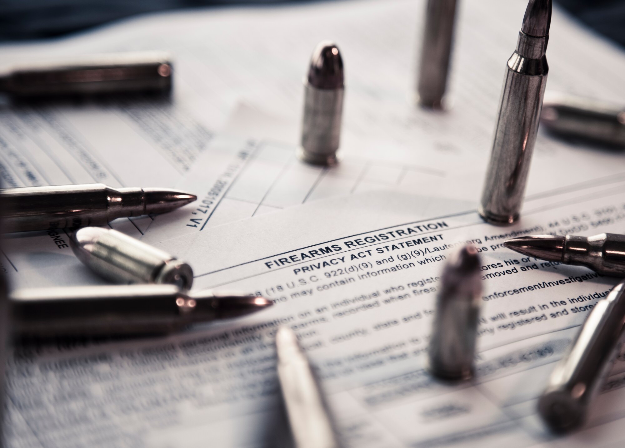 Nine millimeter and 5.56 cartridges sit on top of an AF Form 1314 Firearms Registration form and a DD Form 2760 Qualification to Possess Firearms or Ammunitions form at Minot Air Force Base, N.D., July 10, 2015. According to Staff Sgt. Justin McCoy, 5th Security Forces Squadron assistant NCO in charge of armory operations, if you reside in base housing, you are authorized by the installation commander to keep your personally owned weapons in your home, provided you register them with the 5th SFS Armory. (U.S. Air Force photo/Airman 1st Class Justin T. Armstrong)