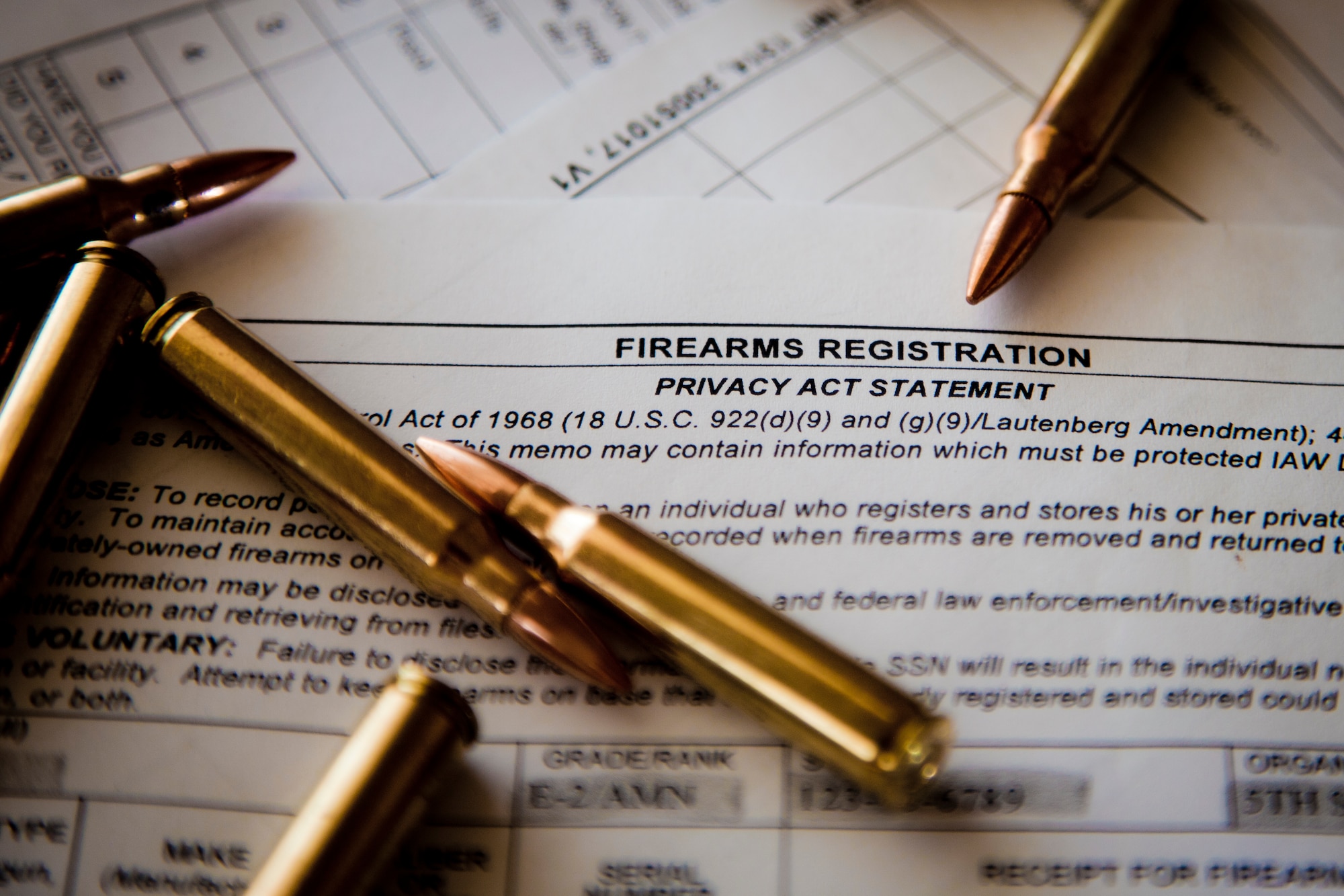 Six 5.56 cartridges sit on top of an AF Form 1314 Firearms Registration form and a DD Form 2760 Qualification to Possess Firearms or Ammunitions form at Minot Air Force Base, N.D., July 10, 2015. According to Staff Sgt. Justin McCoy, 5th Security Forces Squadron assistant NCO in charge of armory operations, if you reside in base housing, you are authorized by the installation commander to keep your personally owned weapons in your home, provided you register them with the 5th SFS Armory. (U.S. Air Force photo/Airman 1st Class Justin T. Armstrong)