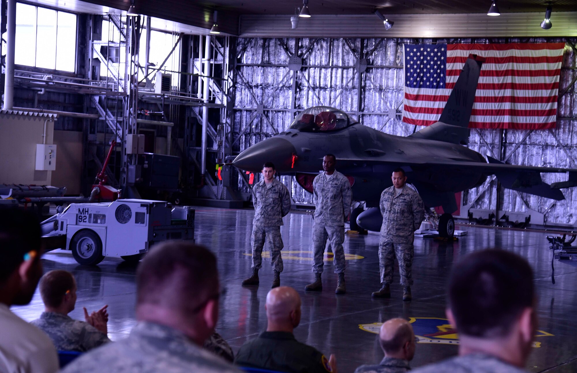 Load crew Airmen from the 13th Aircraft Maintenance Unit’s Team One wait for the beginning of the 3rd quarter load crew competition at Misawa Air Base, Japan, July 17, 2015. The team’s performance is evaluated by inspectors who look for discrepancies throughout the loading process. (U.S. Air Force photo by Airman 1st Class Jordyn Fetter/Released)