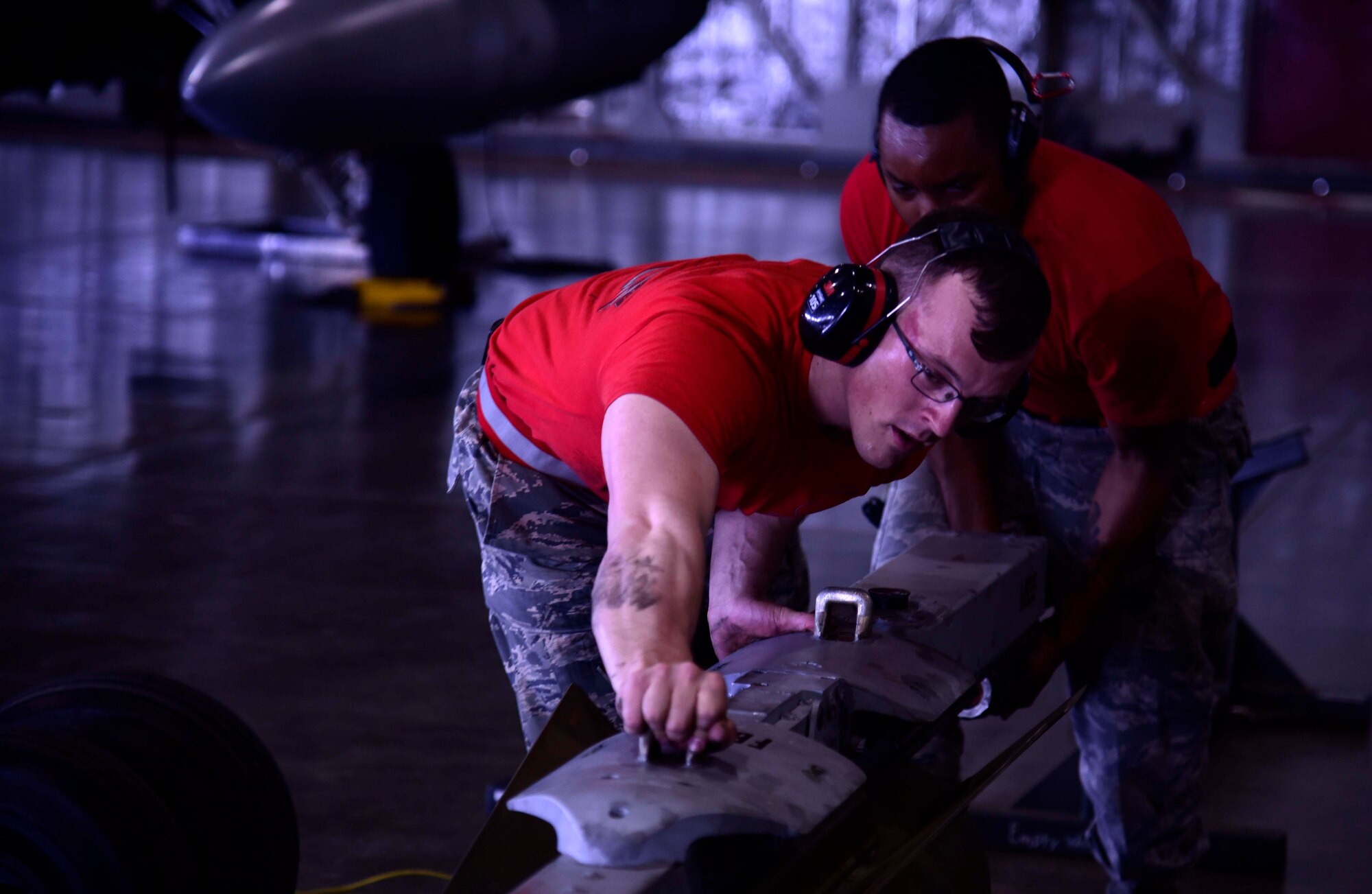 U.S. Air Force Senior Airman Kyle Faragher and Staff Sgt. Michael Barnes, 13th Aircraft Maintenance Unit load crew members, compete in the 3rd quarter load crew competition at Misawa Air Base, Japan, June 17, 2015. This competition evaluated the load crew team’s overall loading ability, which includes quality of work and finishing time. (U.S. Air Force photo by Airman 1st Class Jordyn Fetter/Released)
