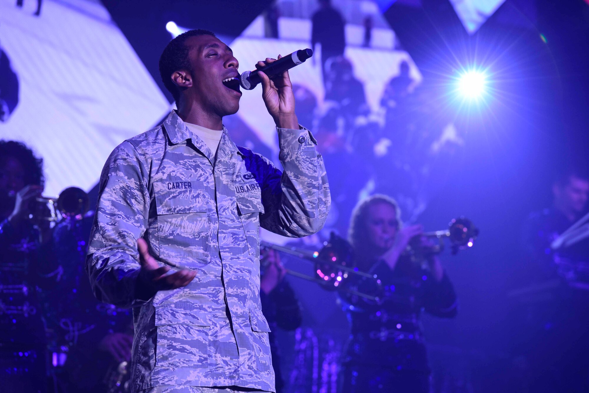 Senior Airman Rashaun Carter sings a solo at the Misawa Civic Center in Misawa, Japan, July 16, 2015. The Air Force Tops in Blue performed their first overseas show at Misawa. (U.S. Air Force photo by Airman 1st Class Jordyn Fetter/Released)