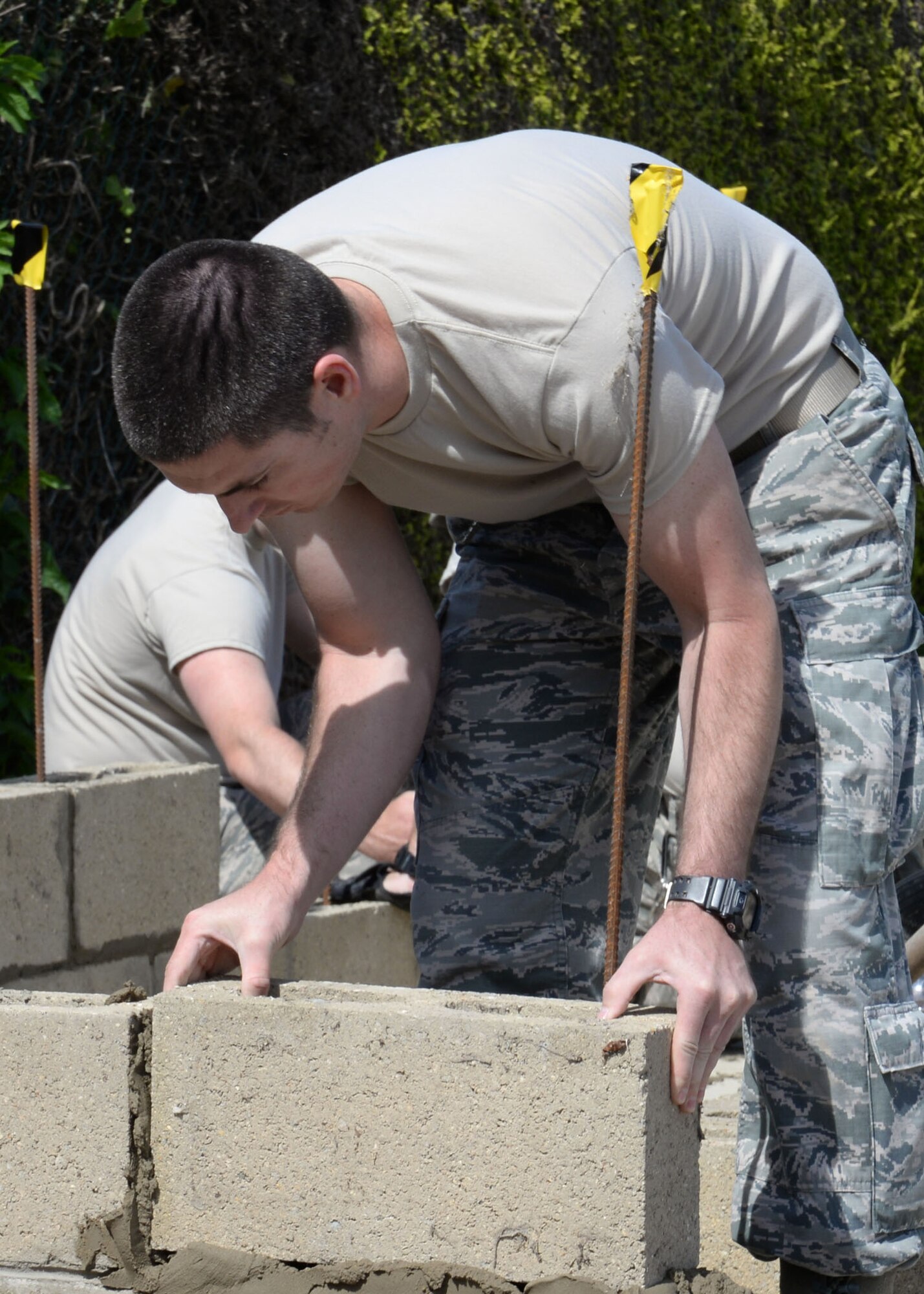 U.S. Air Force Staff Sgt. Scott Francom, 100th Civil Engineer Squadron Structural journeyman from Ogden, Utah, places a concrete block on a bed of mortar June 18, 2015, on RAF Mildenhall, England. The Airman was laying foundations for a new building. (U.S. Air Force photo by Gina Randall/Released) 