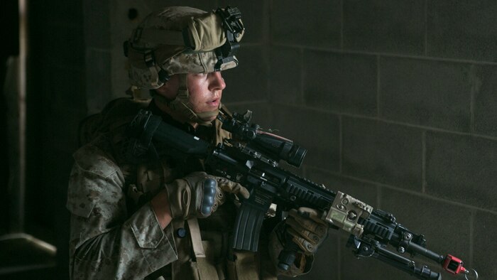 A Marine with Golf Company, 2nd Battalion, 2nd Marines clears an enemy building during a military operations in urban terrain training event at Marine Corps Base Camp Lejeune, North Carolina, July 15, 2015. The Marines cleared buildings that housed enemy troops in order to secure the building and use it to their advantage.