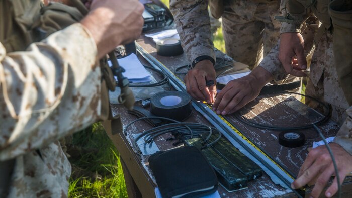 Marines with 2nd Combat Engineer Battalion and 1st Battalion, 8th Marine Regiment, measure detonation cord and create breaching charges during the urban breaching portion of a demolition package at Marine Corps Base Camp Lejeune, North Carolina, July 10, 2015. The demolition package was conducted in preparation for an upcoming deployment, where the two units will be working together in support of Special-Purpose Marine Air-Ground Task Force Crisis Response- Africa. 