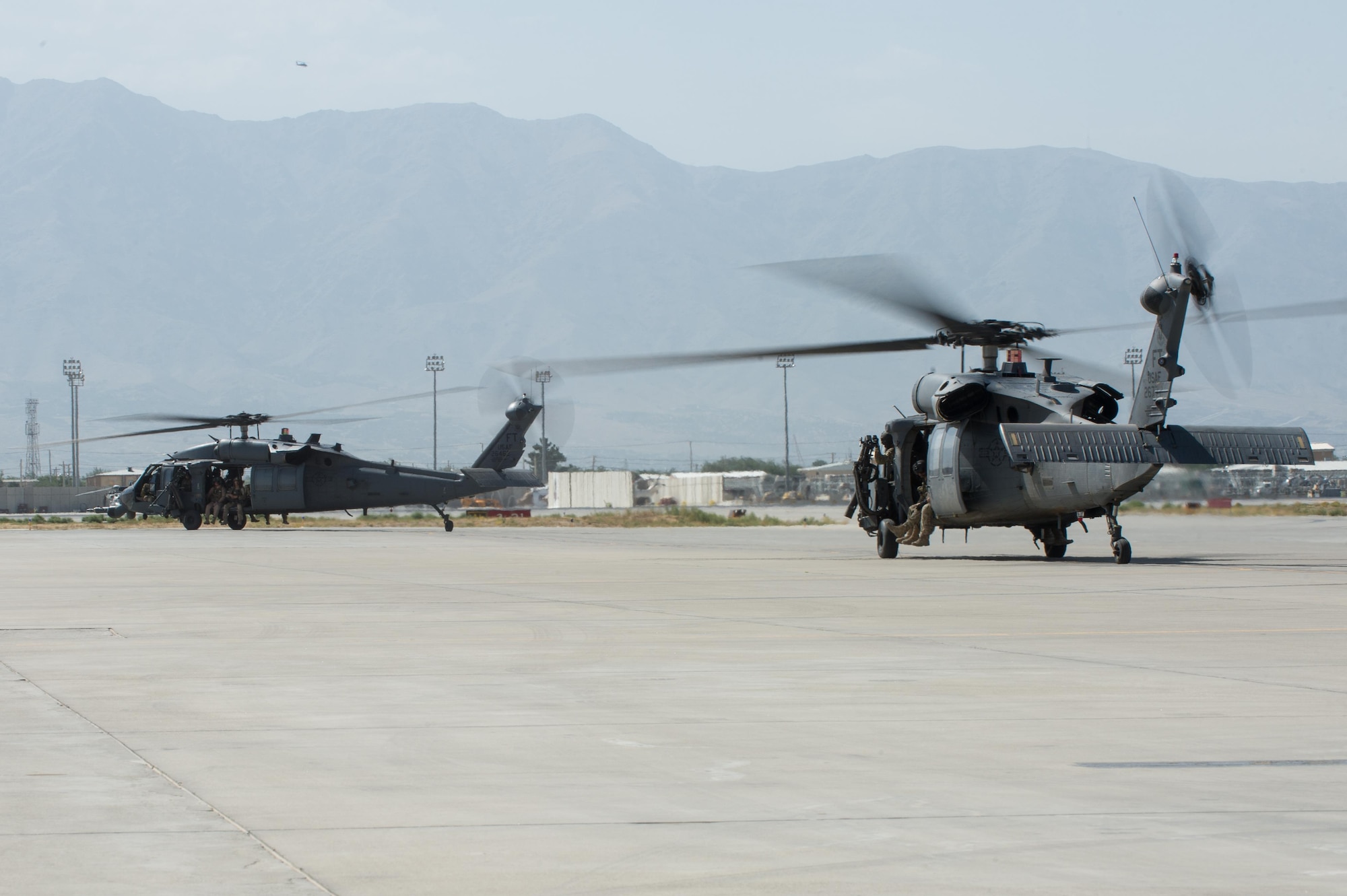 U.S. Air Force HH-60 Pave Hawk helicopters with Guardian Angel team members assigned to the 83rd Expeditionary Rescue Squadron prepare to take off on a training mission July 16, 2015, at Bagram Airfield, Afghanistan. 83rd ERQS mission is to rescue, recover, and return American or allied forces in times of danger or extreme duress.  (U.S. Air Force photo by Tech. Sgt. Joseph Swafford/Released)
