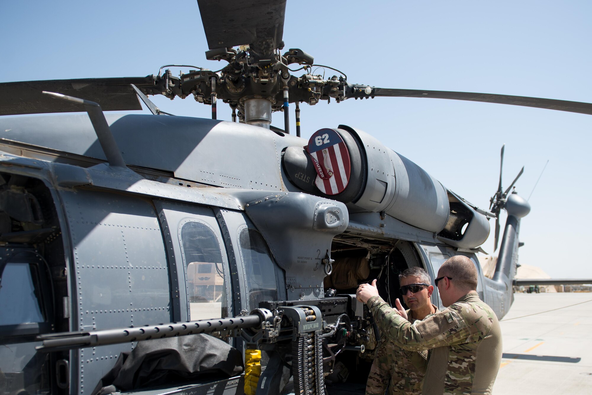 U.S. Air Force Brig. Gen. Dave Julazadeh, 455th Air Expeditionary Wing commander, left, is given a tour of a HH-60 Pave Hawk helicopter by a Special Mission Aviator assigned to the 83rd Expeditionary Rescue Squadron at Bagram Airfield, Afghanistan, July 16, 2015. Julazadeh took part in a training mission with the Aircrew and Guardian Angels of the 83 ERQS to see firsthand how they contribute to the mission in Afghanistan. (U.S. Air Force photo by Tech. Sgt. Joseph Swafford/Released)